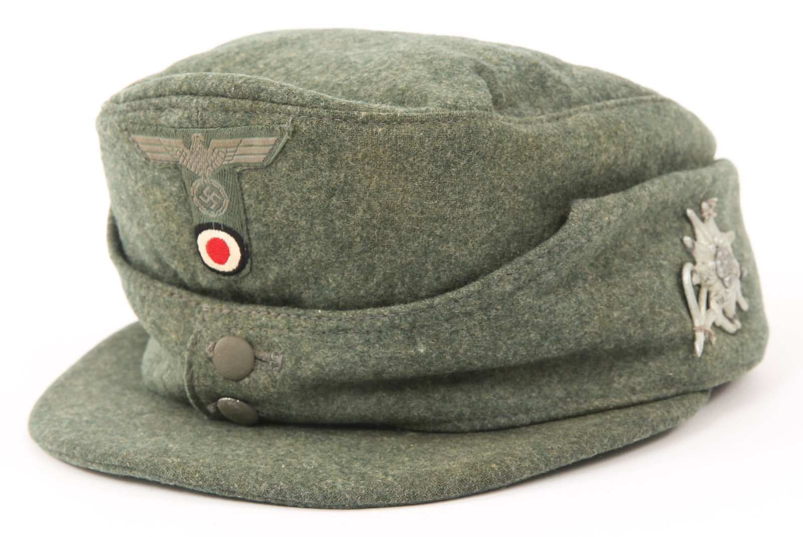 WWII GERMAN OFFICER'S M43 CAP WITH EDELWEISS PIN: WWII GERMAN OFFICER'S M43 CAP WITH EDELWEISS PIN WWII German Army Officer's M43 cap with Edelweiss pin sewn onto to the ear warmer flaps on the side of the cap. Frontal insignia is a single piece of c