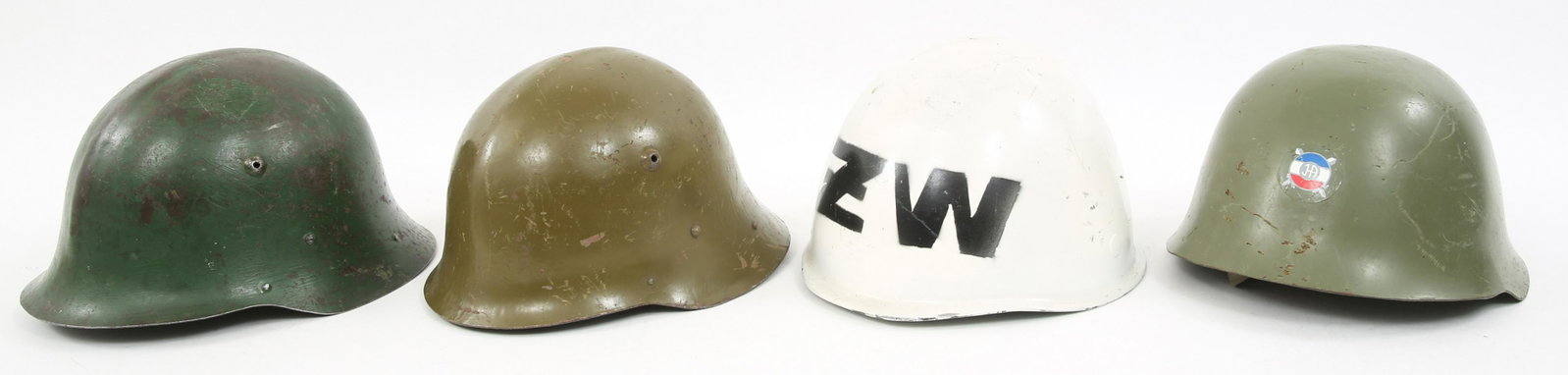 BULGARIAN & WORLD MILITARY HELMETS LOT OF 4: BULGARIAN & WORLD MILITARY HELMETS LOT OF 4 Lot of 4 world military helmets. (1) Polish Military Police helmet, white painted with stenciled decal. (1) Yugoslavian M59 helmet with Slovenian decal. (1)