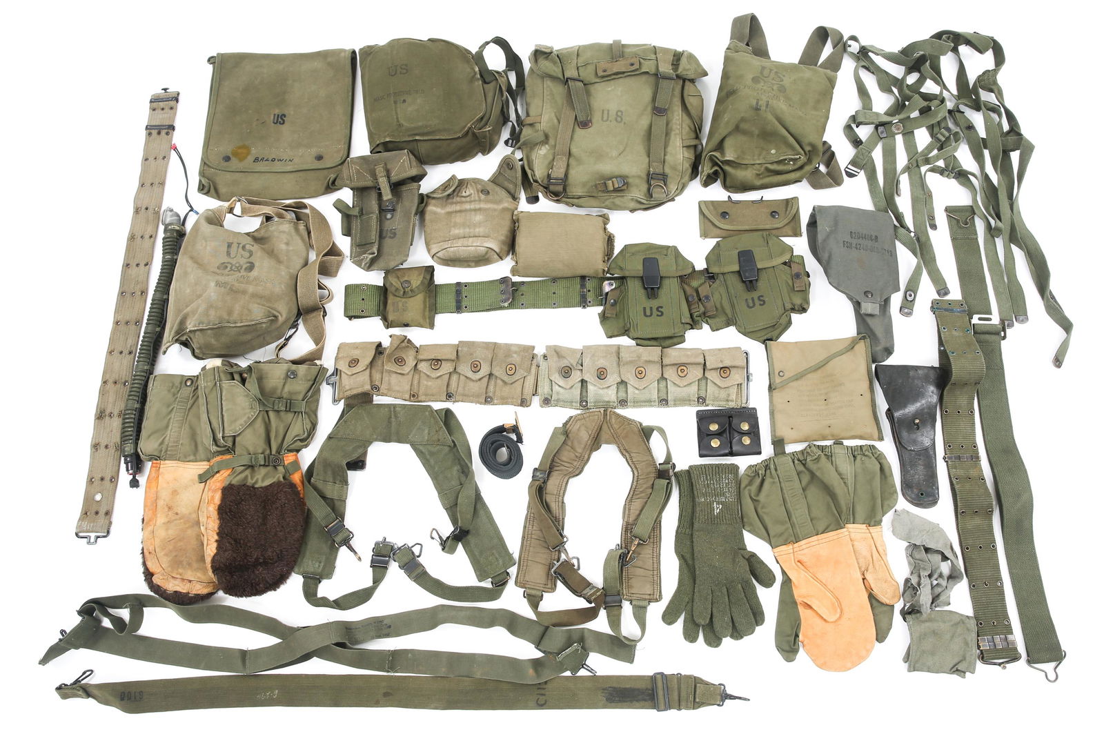 US ARMY COLD WAR FIELD GEAR & GAS MASKS LOT: US ARMY COLD WAR FIELD GEAR & GAS MASKS LOT WWII US Army mixed field gear and gas masks lot. M9A1 gas mask in case, M17 gas mask in case, gas mask hose, canteen case, ammo pouch / clip belt, cold weat