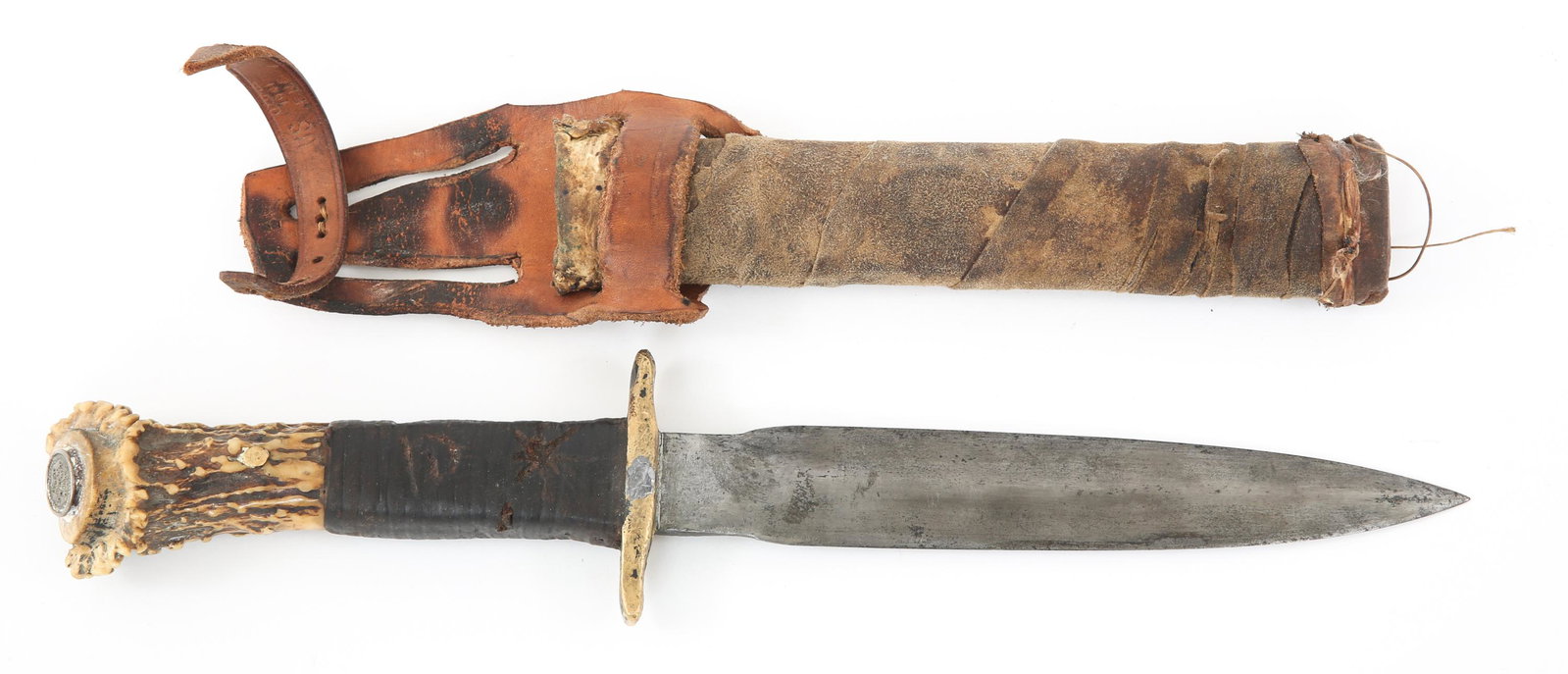 1941 DATED STAG HORN DAGGER WITH LEATHER SHEATH: 1941 DATED STAG HORN DAGGER WITH LEATHER SHEATH 1941 Dated Custom Made Stag Horn Dagger with Leather Sheath. Dagger blade, brass crossguard. Leather wrapped stag horn handle. Pommel has a circular met