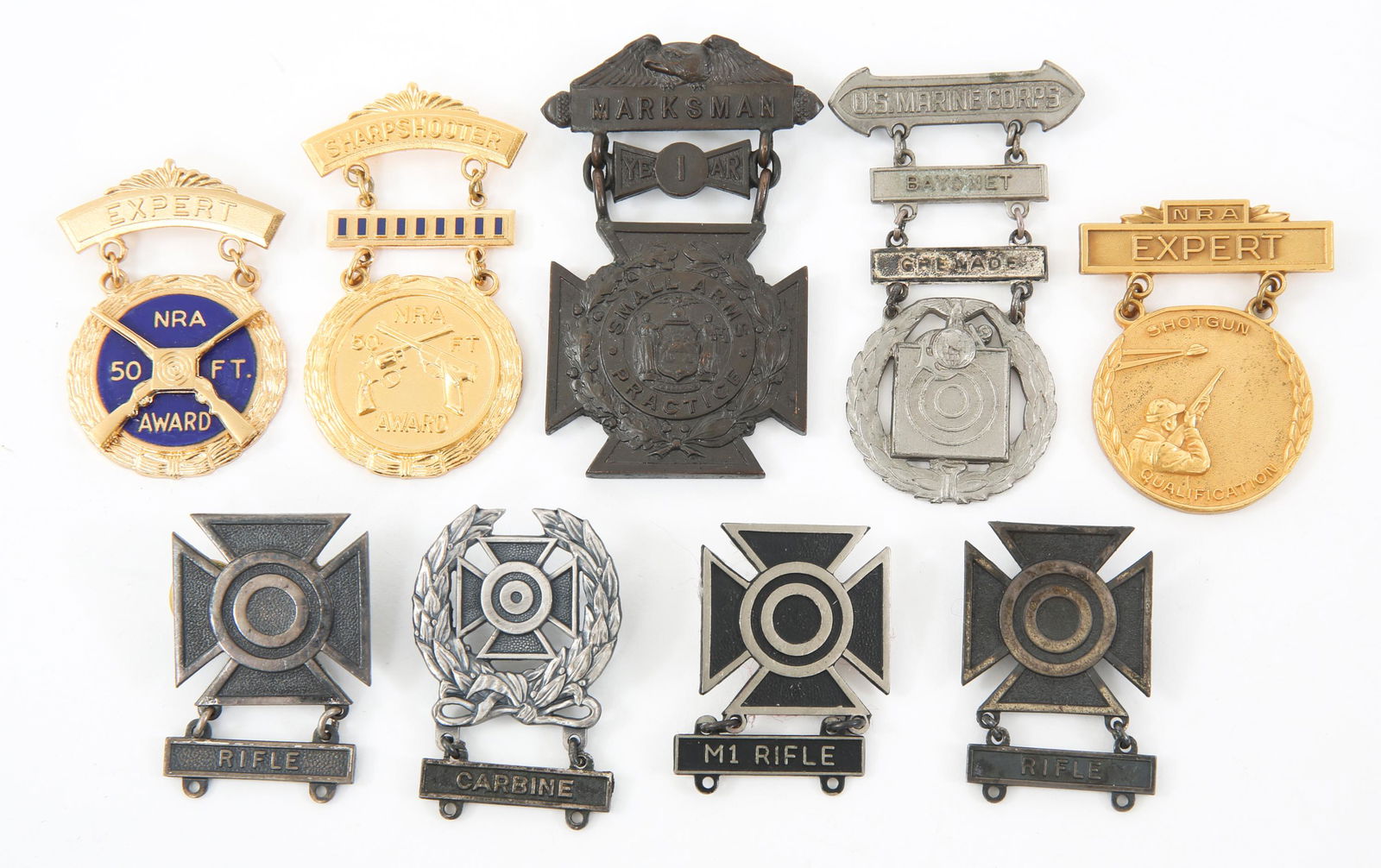 US ARMY - USMC - NRA MARKSMAN QUALIFICATION BADGES: US ARMY - USMC - NRA MARKSMAN QUALIFICATION BADGES Mixed lot of 9 Marksman badges. (1) WWI NYNG 1 year small arms practice Marksman badge. Maker Marked "Tiffany & Co". (1) USMC qualification badge wit