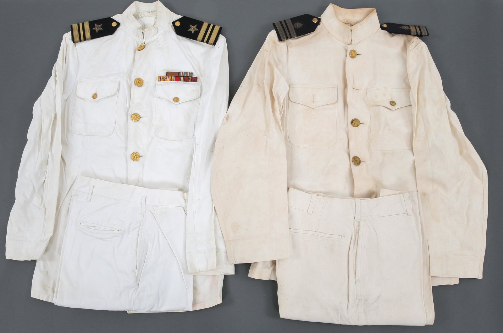 WWII COLD WAR USN OFFICER WHITE DRESS UNIFORM LOT: WWII COLD WAR USN OFFICER WHITE DRESS UNIFORM LOT WWII to Cold War era, US Navy Officer white dress uniform lot. (1) USN Medical Lt Commander white tunic with shoulder boards & pants. (1) USN Lt Comma