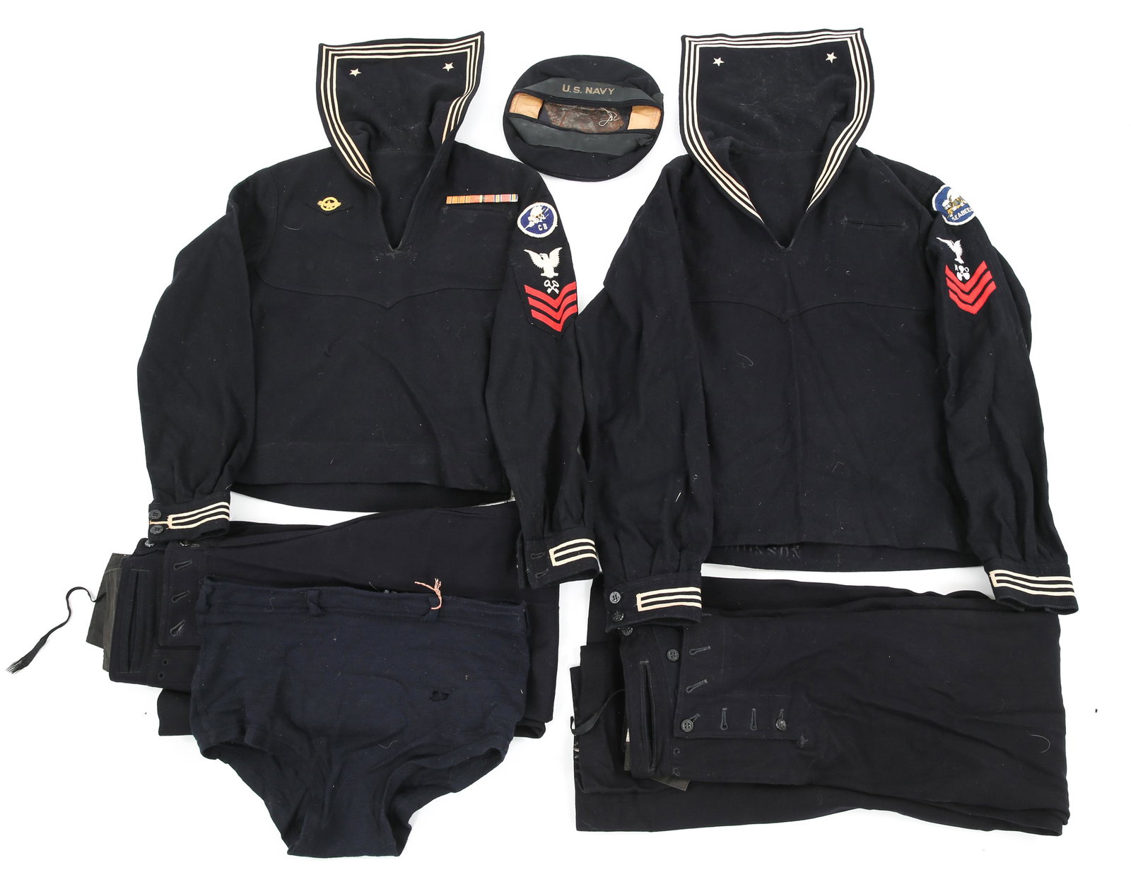 WWII US NAVY SEABEES DRESS BLUE JUMPER UNIFORMS: WWII US NAVY SEABEES DRESS BLUE JUMPER UNIFORMS WWII US Navy Seabees dress blue jumper uniforms lot. (2) Set of tunics and pants. (1) Navy swim trunks. Size: Small