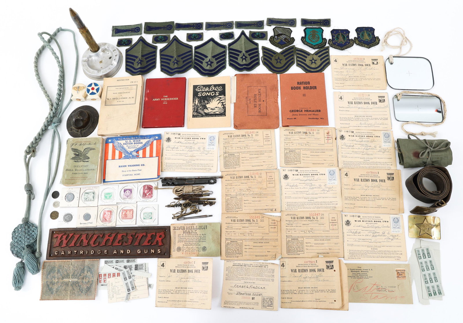 MILITARY COLLECTIBLES BONANZA LOT: MILITARY COLLECTIBLES BONANZA LOT Military Collectibles Bonanza lot. Includes Home Front trench art, WWI & WWII guide books, WWII German Nazi Stamps and coins, Rifle cleaning kit, USAF survival mirror