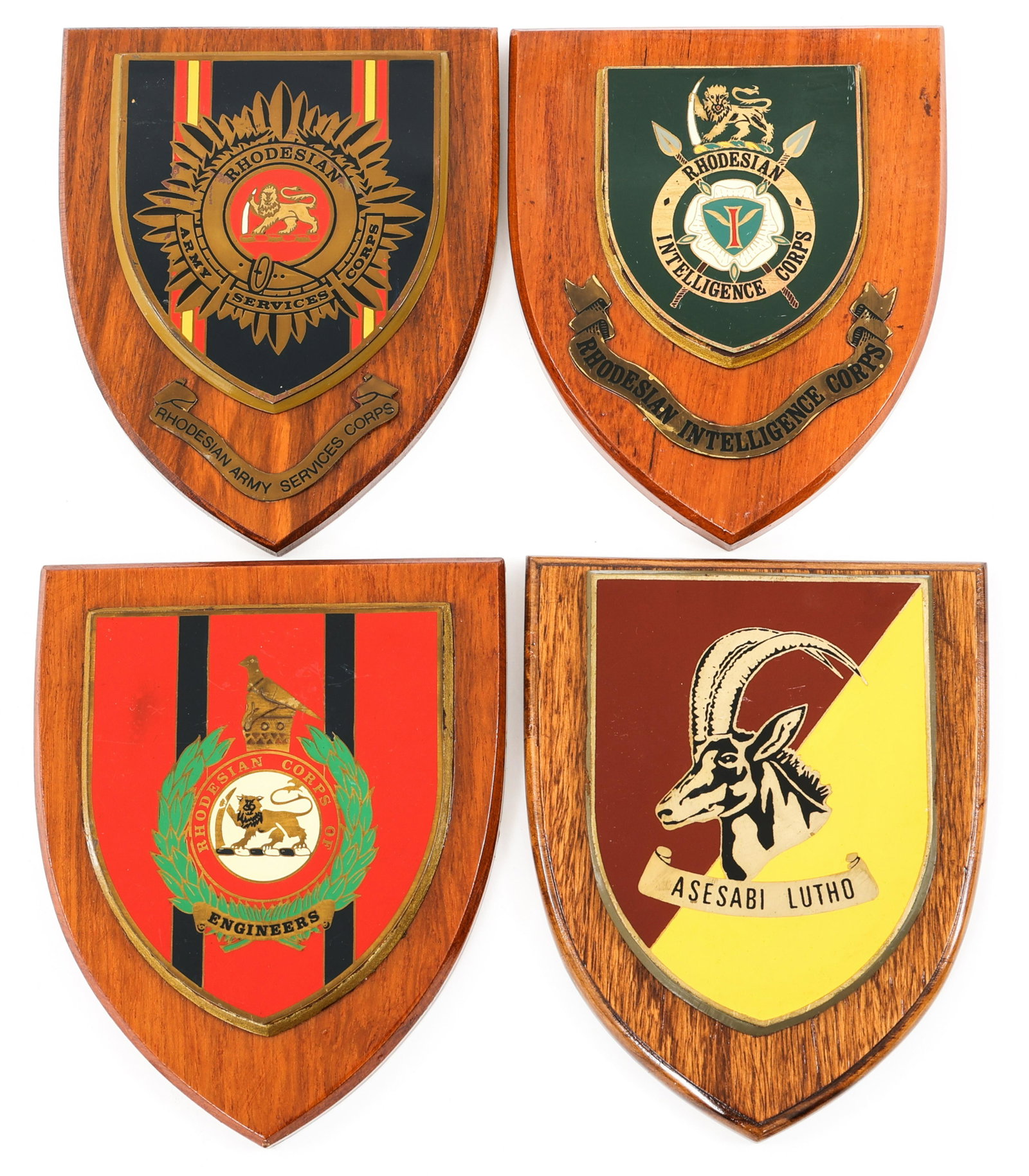 RHODESIAN INTELLIGENCE & OTHER CORPS PLAQUES LOT: RHODESIAN INTELLIGENCE & OTHER CORPS PLAQUES LOT Lot of 4 Rhodesian plaques. (1) Rhodesian Intelligence Corps. (1) Rhodesian Armored Corps. (1) Rhodesian Corps of Engineers. (1) Rhodesian Army Service