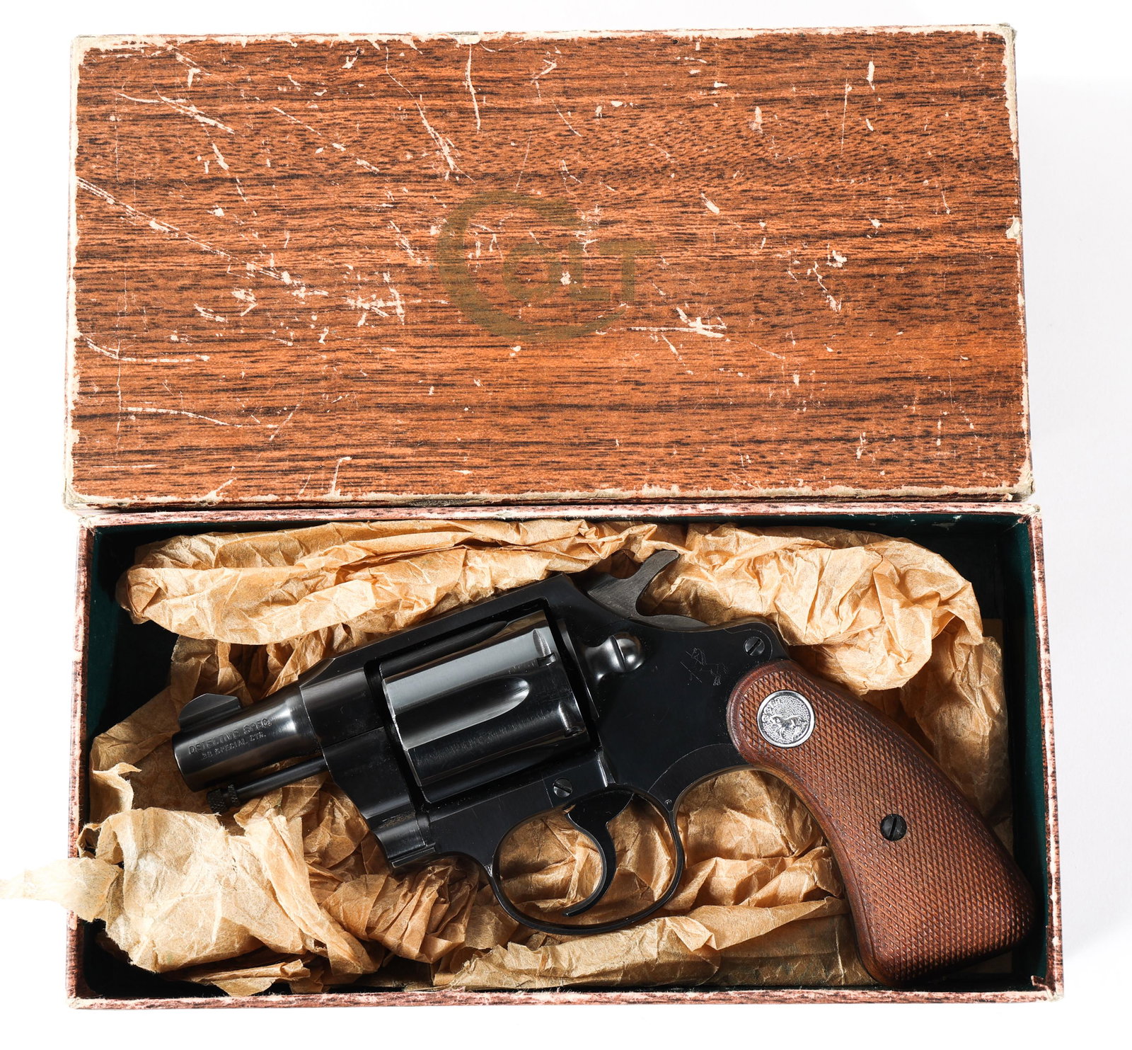1956 COLT DETECTIVE SPECIAL 38 CALIBER REVOLVER: 1956 COLT DETECTIVE SPECIAL 38 CALIBER REVOLVER 1956 Colt Model Detective Special .38 caliber 6 shot, double action revolver. Barrel stamped "Detective Spec. .38 Special CTG". Checkered wood grips. Fa
