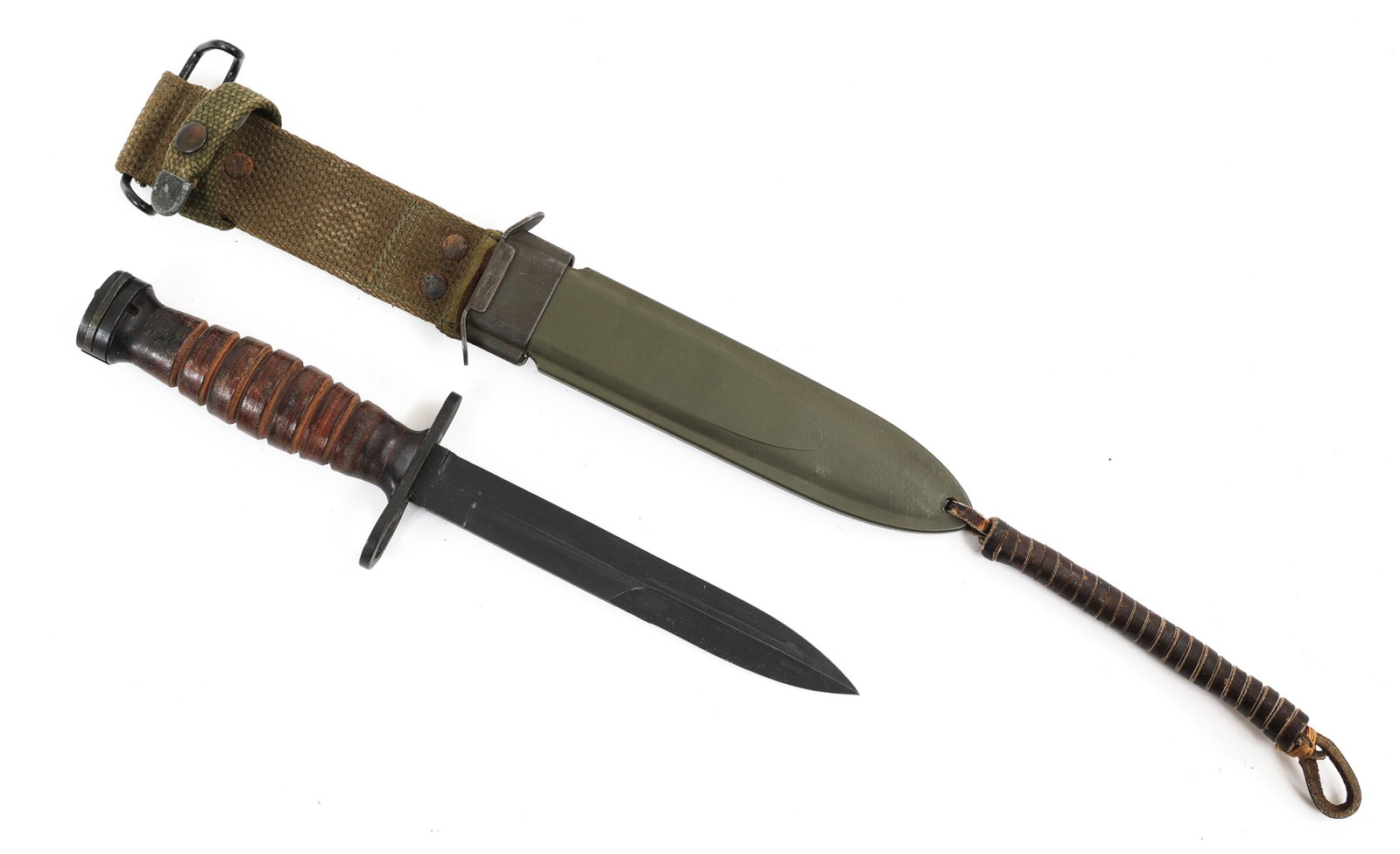 WWII US ARMY M4 CARBINE BAYONET By CAMILLUS: WWII US ARMY M4 CARBINE BAYONET By CAMILLUS | WWII US Army M4 carbine bayonet with USM8A1 Scabbard. Spear point parkerized blade (99% remaining) . Maker marked "US M4 Camillus" stamped under the guard