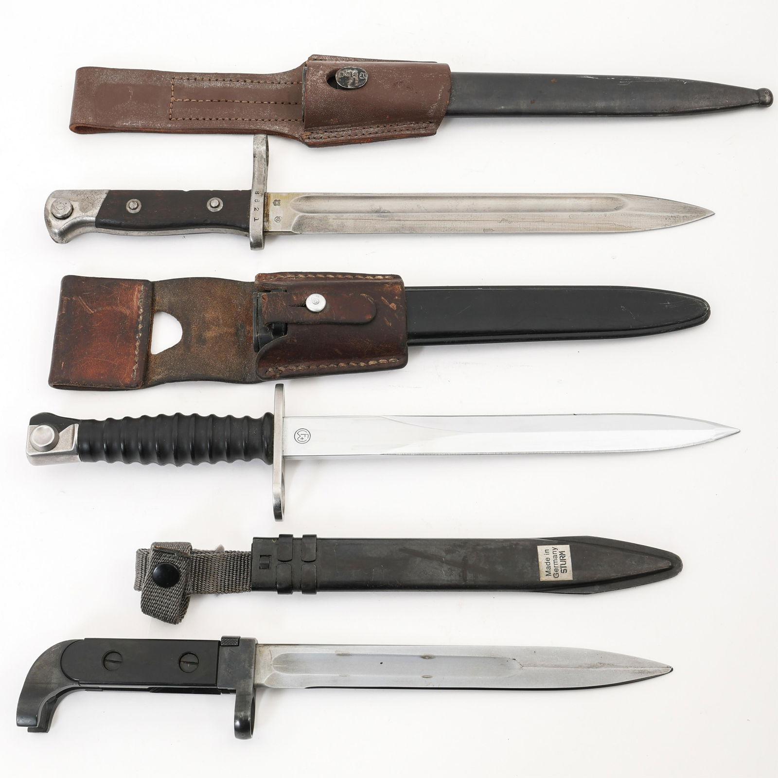 WWII - COLD WAR WORLD MILITARY BAYONET LOT OF 3: WWII - COLD WAR WORLD MILITARY BAYONET LOT OF 3 Lot of three world military bayonets from WWII through Cold War era. Includes: (1) Swiss Sig57 bayonet. Leather M1957 belt frog, embossed "Theurillat St