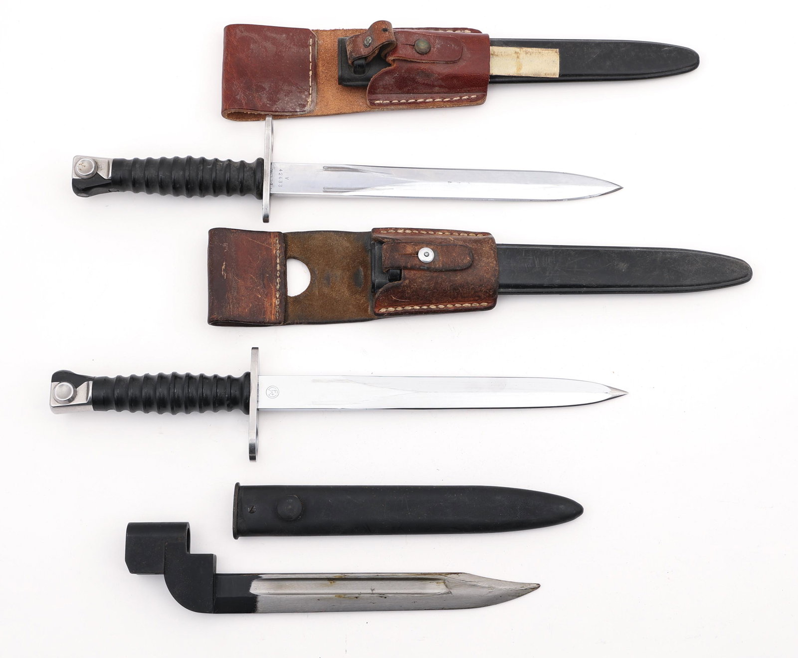SWISS SIG57 AND BRITISH NO9 MK1 BAYONETS: SWISS SIG57 AND BRITISH NO9 MK1 BAYONETS Lot of European WWII bayonets. Includes:(2) Swiss Sig57 bayonets with leather frogs and plastic scabbards. Maker's marks and serial numbers on ricassos. 9.25" 
