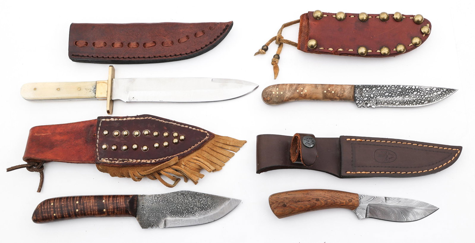 CUSTOM US HUNTING KNIVES LOT OF 4: CUSTOM US HUNTING KNIVES LOT OF 4 Lot of 4 US custom hunting knives. Includes: (1) 3.5" feather Damascus blade knife. 7" overall length. Leather sheath. (1) 4.5" bench made bladed knife. 9" overall le