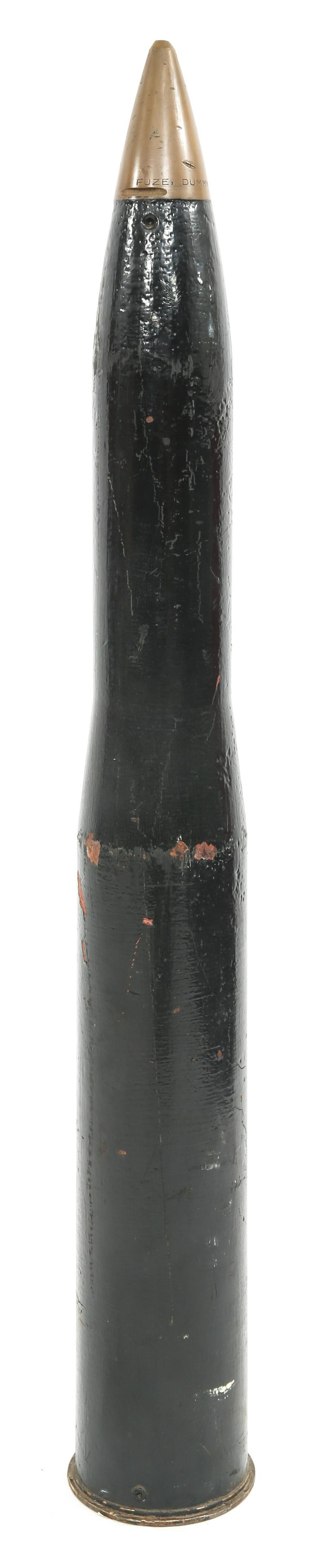 TRAINING DUMMY ARTILLERY SHELL DISPLAY CARTRIDGE: TRAINING DUMMY ARTILLERY SHELL DISPLAY CARTRIDGE Training dummy / display artillery shell cartridge. Black painted. Measures 37.25" in height. Projectile tip is marked "Fuze, Dummy". Weighs 40 LBS. No