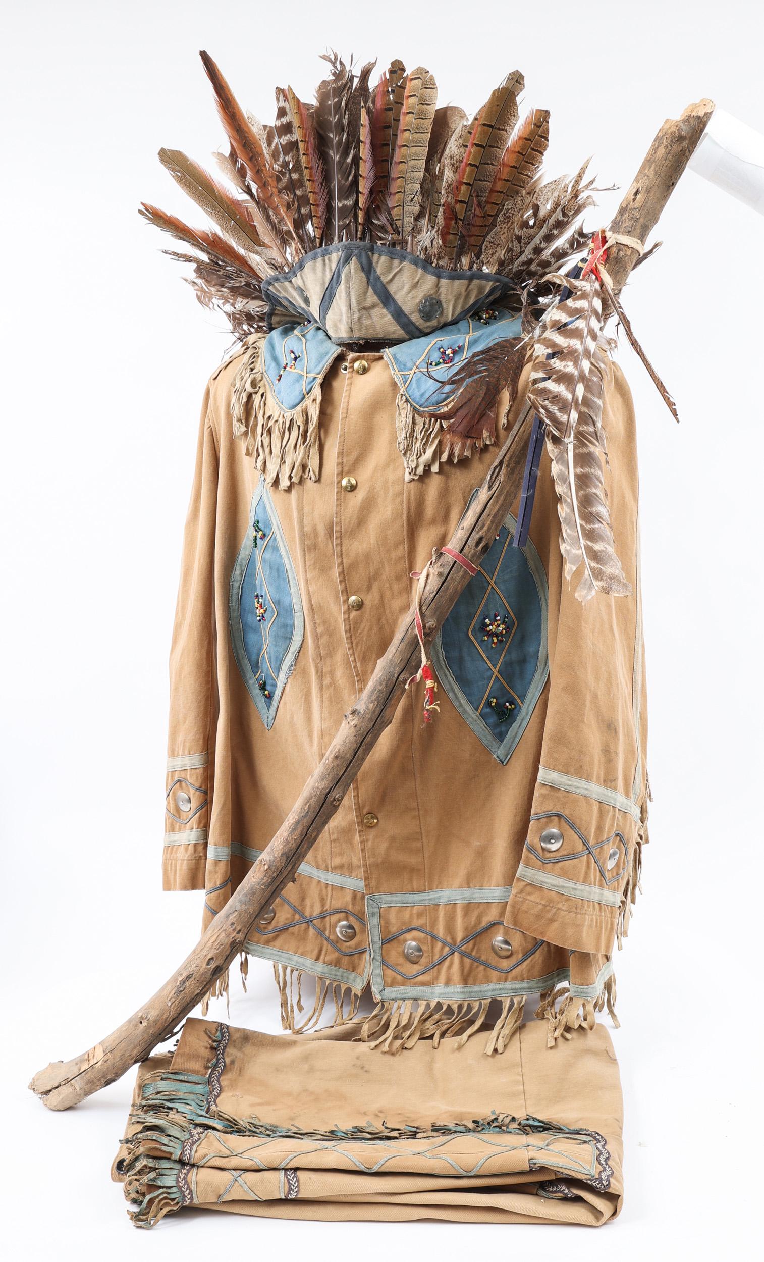 WILD WEST SHOWS KHAKI TWILL INDIAN DRESS UNIFORM: WILD WEST SHOWS KHAKI TWILL INDIAN DRESS UNIFORM Early 1900's Wild West Shows, Khaki twill Indian Dress Uniform. Including; Tunic, Trousers, Feather Headdress and Walking Cane. Size: Medium