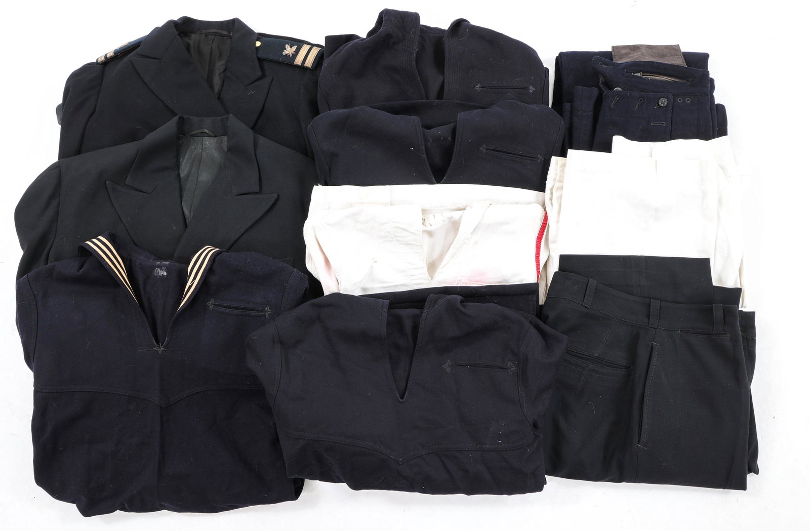 WWI - COLD WAR US NAVY UNIFORM LOT: WWI - COLD WAR US NAVY UNIFORM LOT Mixed lot of WWI - WWII US Navy Officer and Enlisted uniforms including (1) Black Officer's tunic with Lieutenant rank, assigned to the Pay Corps. (1) Black US Navy 