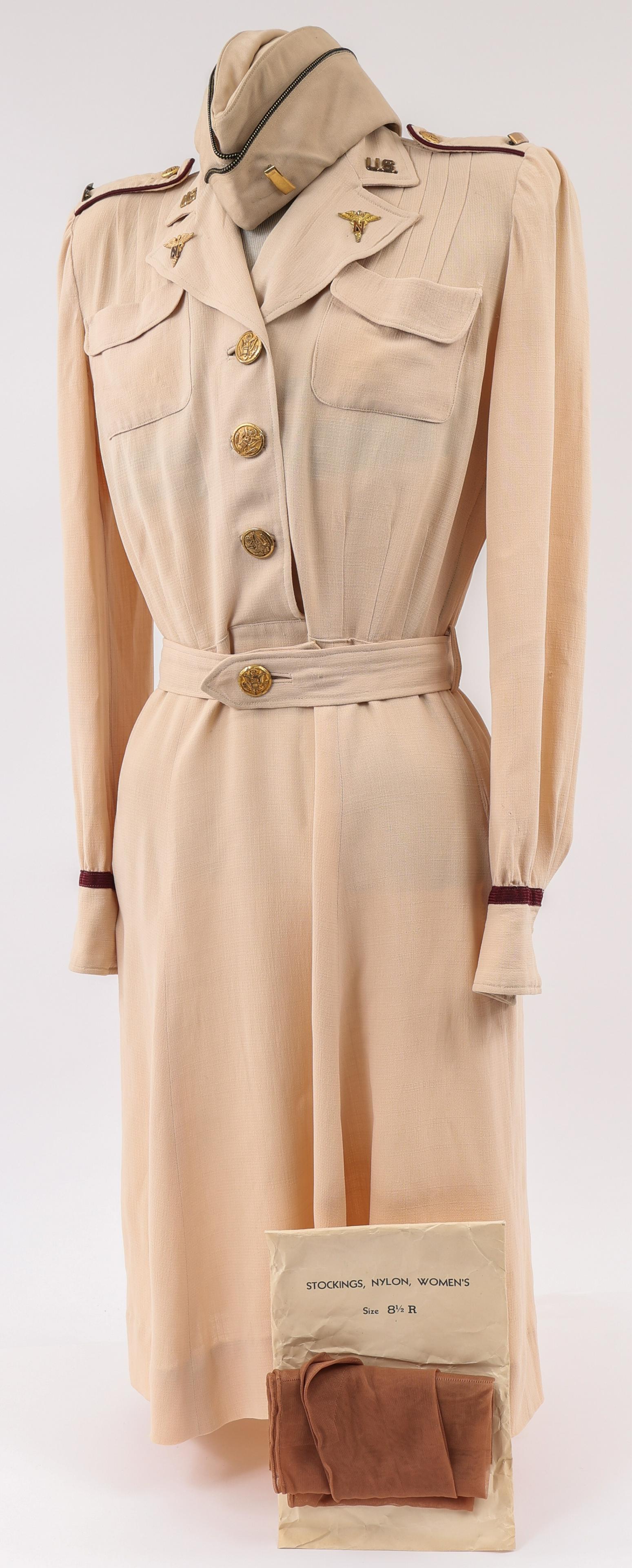 WWII US ARMY NURSE OFF DUTY BEIGE DRESS UNIFORM: WWII US ARMY NURSE OFF DUTY BEIGE DRESS UNIFORM WWII US Army Nurse Officer, Off-Duty Beige Dress Uniform. One piece weave rayon dress with "US" & "Nurse" collar (Amico, Clutch-back), 2nd Lt. bar. With