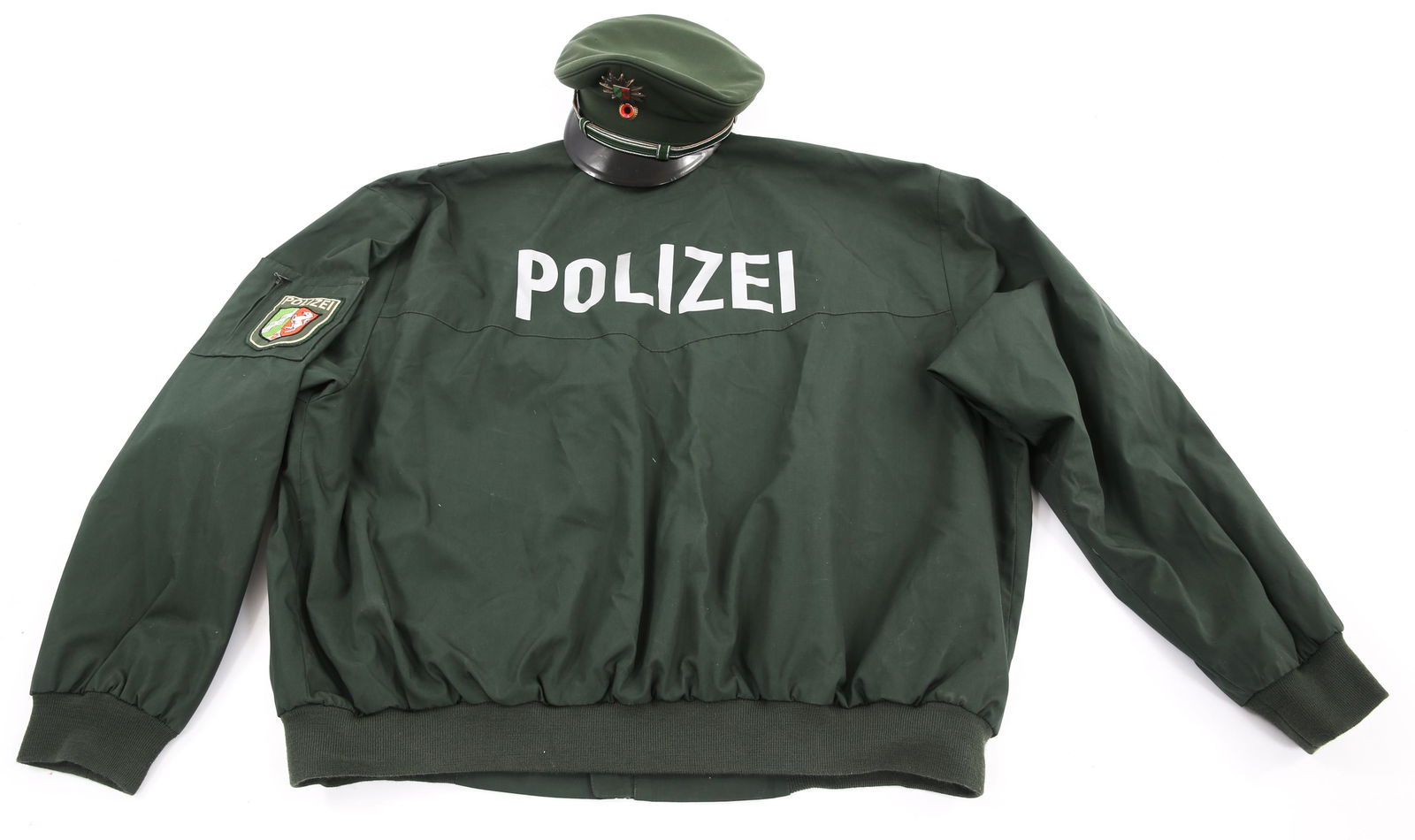 MODERN GERMAN POLIZEI JACKET & CAP: MODERN GERMAN POLIZEI JACKET & CAP Cold War to Modern German Polizei Jacket and Service Cap. (1) North Rhine-Westphalia State Police nylon Jacket. NRW patch on the left shoulder and "Polizei" printed