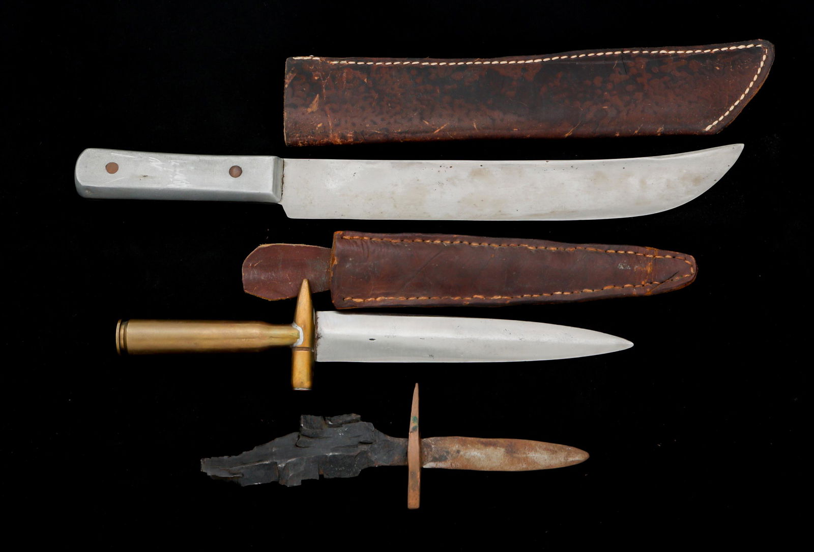 WWII US TRENCH ART KNIVES LOT OF 3: WWII US TRENCH ART KNIVES LOT OF 3 Lot of 3 WWII US Trench Art Knives. (1) WWII Theater made knife. Bright, curved aluminum blade. Hand engraved "H. Burkle" on the aluminum grip. Brown leather sheath.