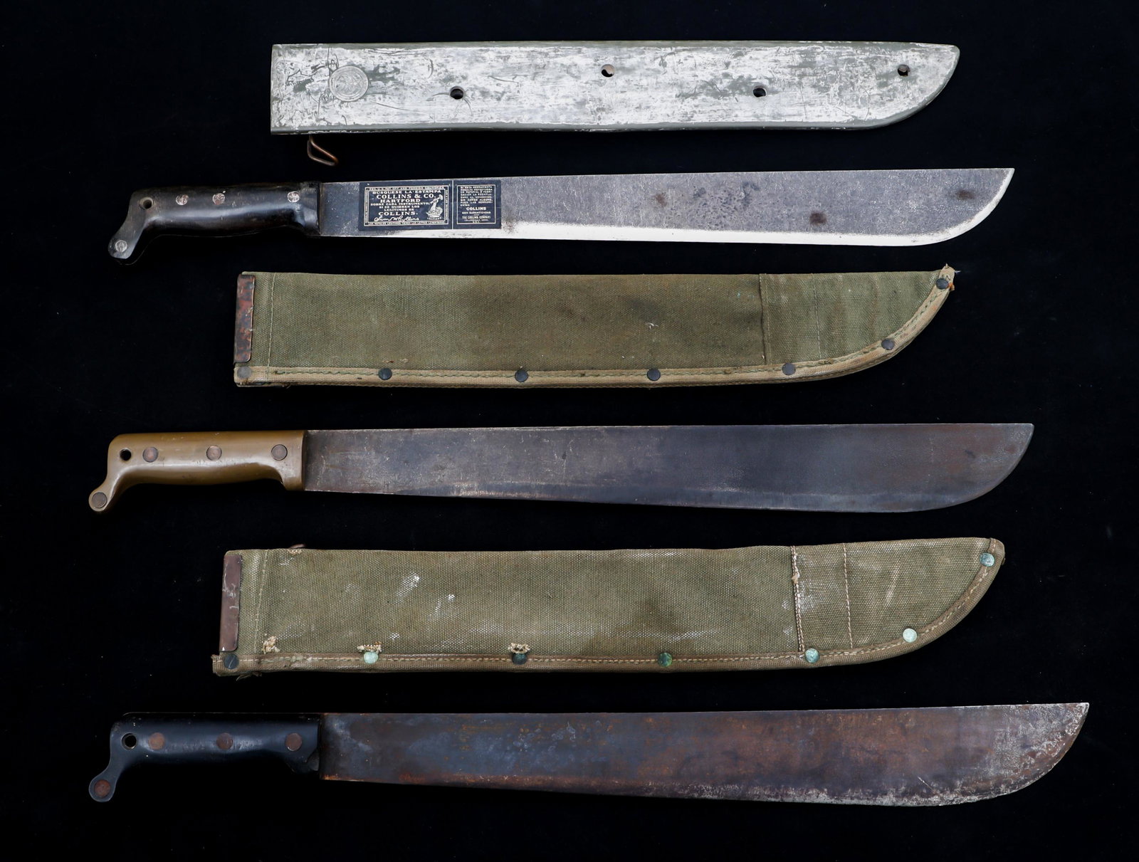 WWII US ARMED FORCES MACHETES LOT OF 3: WWII US ARMED FORCES MACHETES LOT OF 3 Lot of 3 WWII US Military Machetes. (1) Military machete. Straight, machete type blade. Maker mark / logo "True Temper TT - 18 1943 US" on the ricasso. Black pla