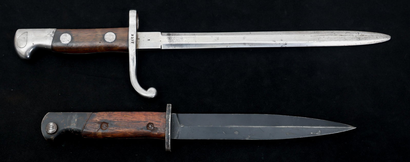 COLD WAR ERA PORTUGAL & DUTCH BAYONETS LOT OF 2: COLD WAR ERA PORTUGAL & DUTCH BAYONETS LOT OF 2 Lot of 2 Cold War Era Portuguese and Dutch Bayonets. (1) Portuguese M948 Bayonet. Spear tip, blued, straight stiletto blade. No visible maker mark. Stee