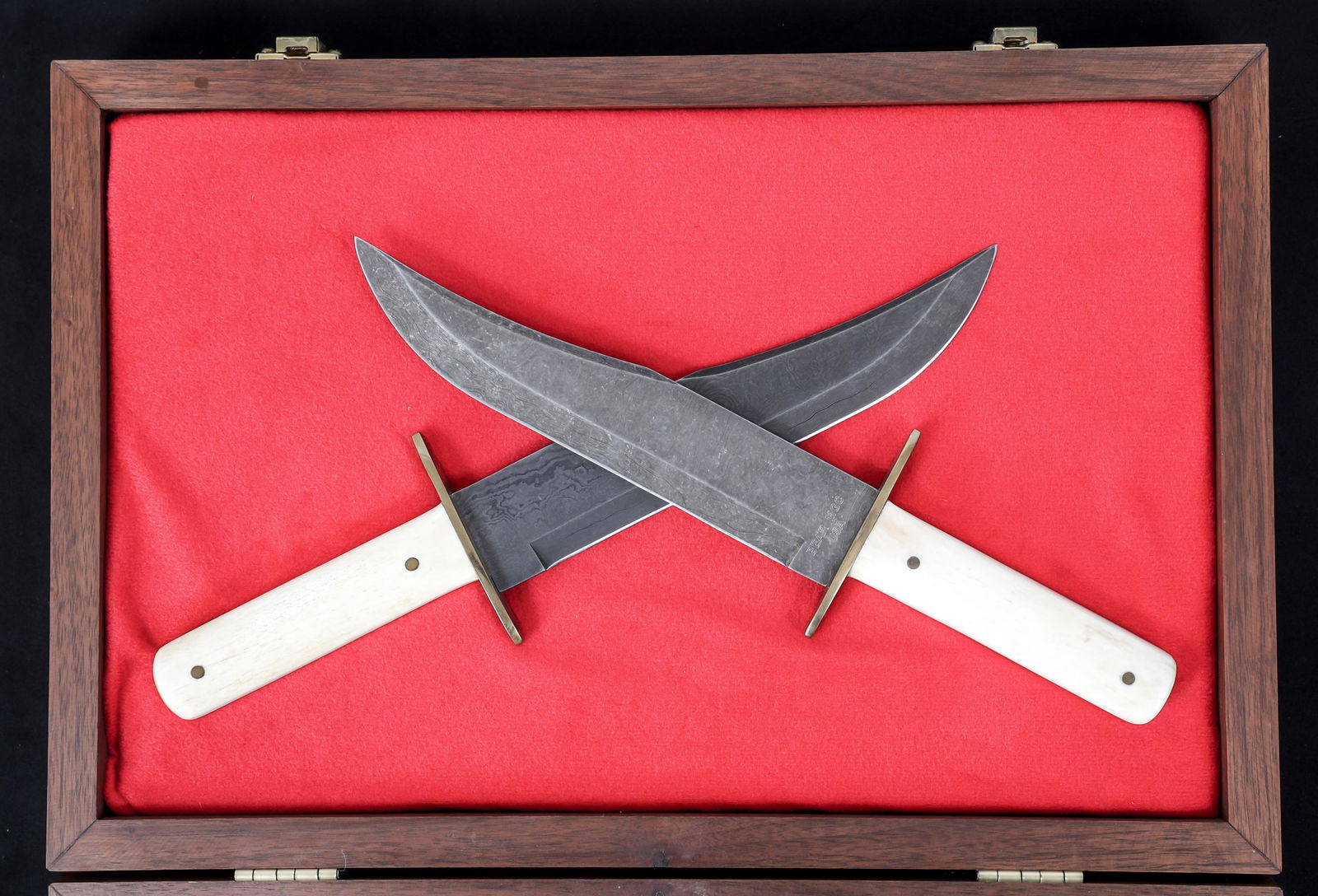 BEAR MGC CUTLERY DAMASCUS BOWIE KNIVES LOT OF 2: BEAR MGC CUTLERY DAMASCUS BOWIE KNIVES LOT OF 2 Lot of 2 Encased Bear MGC Cutlery Damascus Bowie Knives. Bowie type, Damascus steel blades. Maker mark "Bear MGC USA" on the ricasso. Brass crossguard.