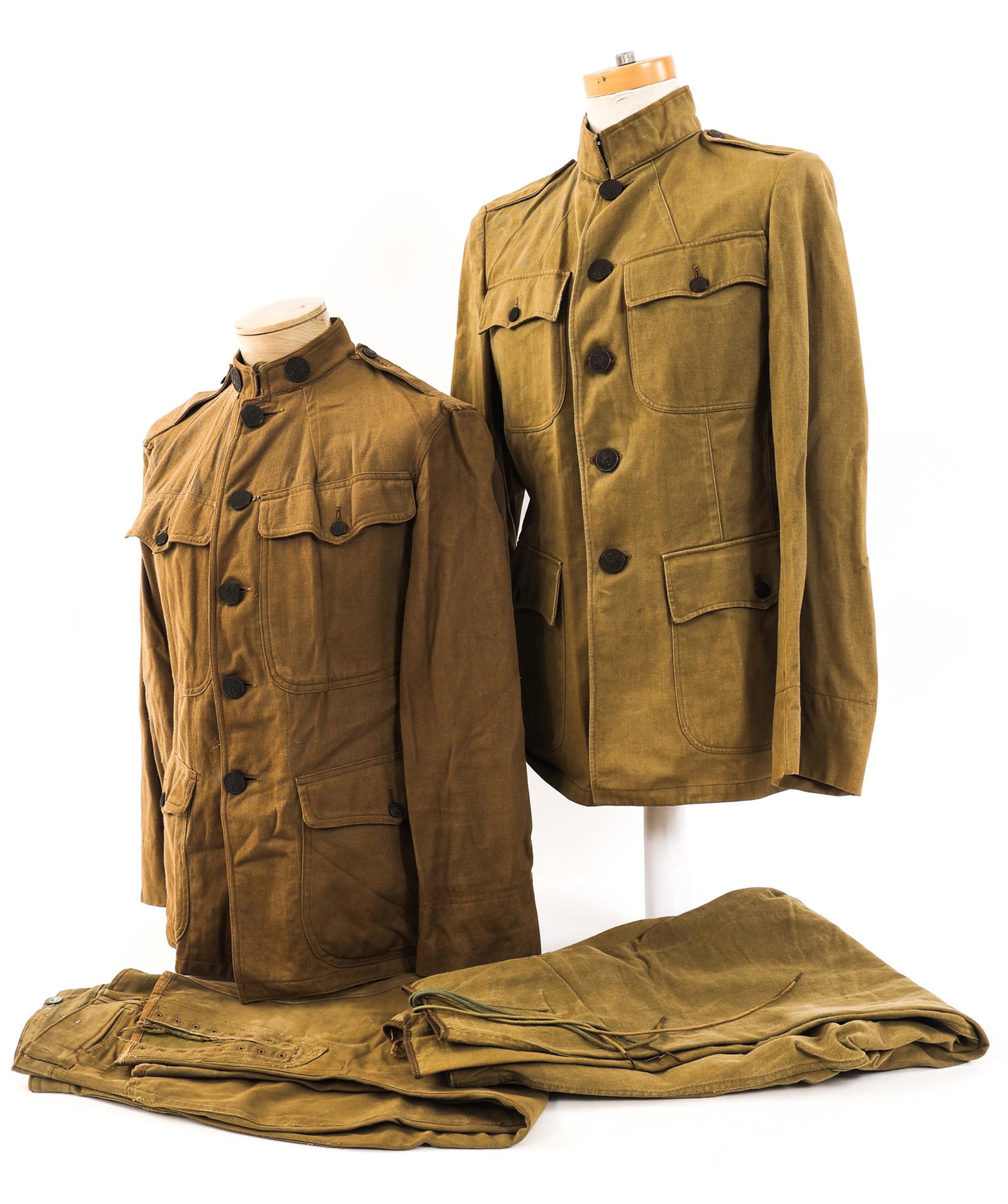 WWI US ARMY M1912 KHAKI SUMMER ENLISTED UNIFORMS: WWI US ARMY M1912 KHAKI SUMMER ENLISTED UNIFORMS Lot of 2 WWI US Army M1912 Enlisted Uniforms. Includes khaki cotton tunics with collar insignia and breeches. Size: small