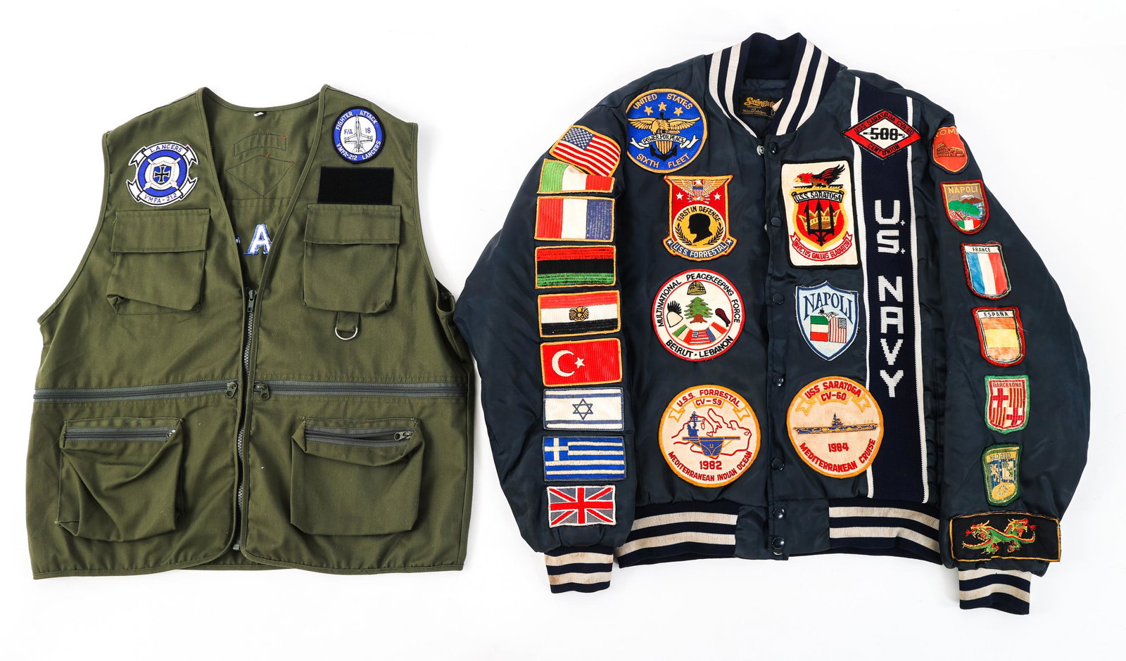 COLD WAR USN COMMEMORATIVE JACKET & VEST LOT: COLD WAR USN COMMEMORATIVE JACKET & VEST LOT Lot of Cold War US Navy Commemorative Jacket and Vest. Navy jacket displays patches from US aircraft carriers USS Forrestal (CV-59) and USS Saratoga (CV-60