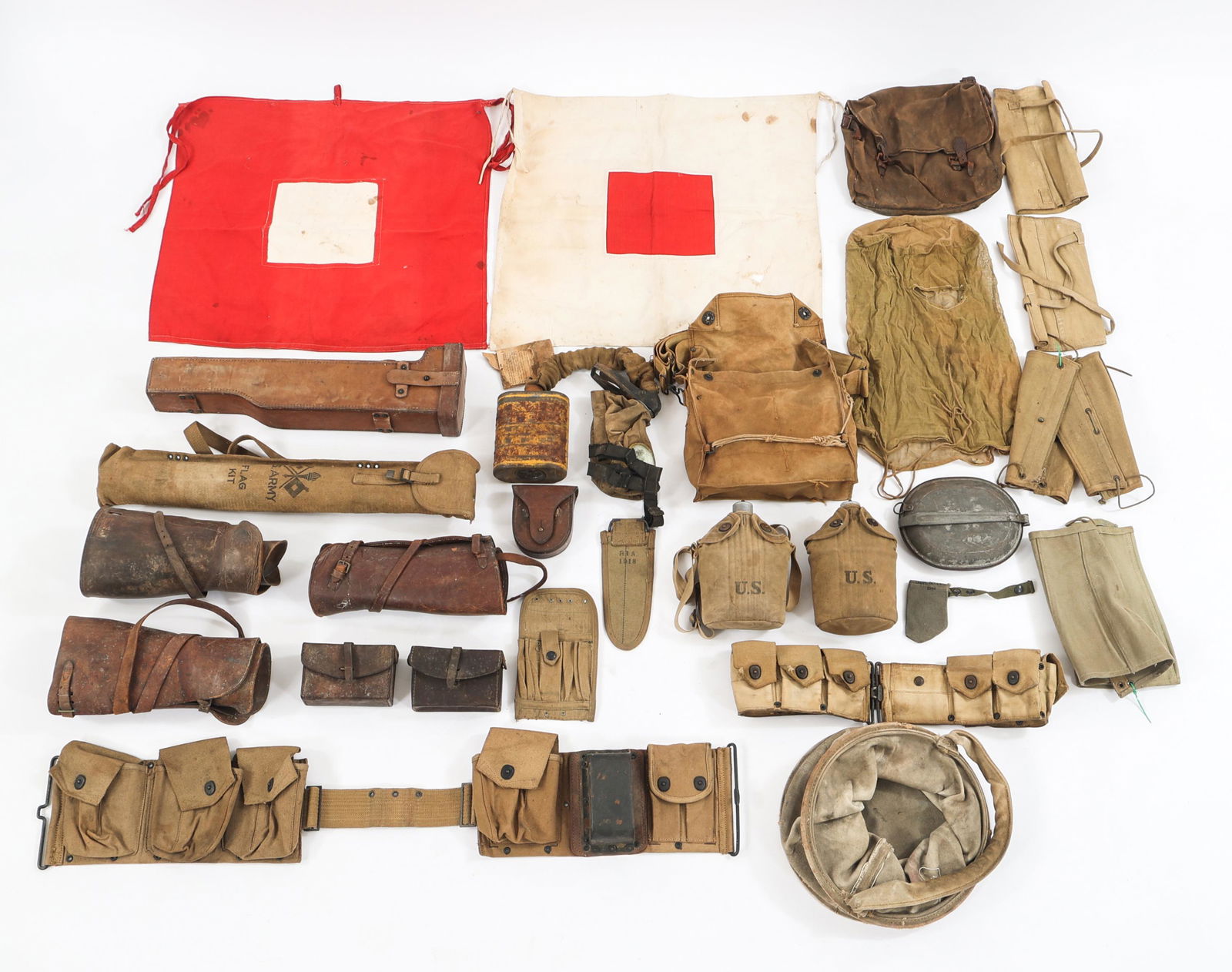 WWI US ARMY GAS MASK & FIELD GEAR LOT: WWI US ARMY GAS MASK & FIELD GEAR LOT Lot of WWI Gas Mask and Field Gear. (1) M1917 gas mask and carrying case. (3) Pairs of leather officers gaiters. (3) Pairs of canvas enlisted gaiters. (1) US Sign