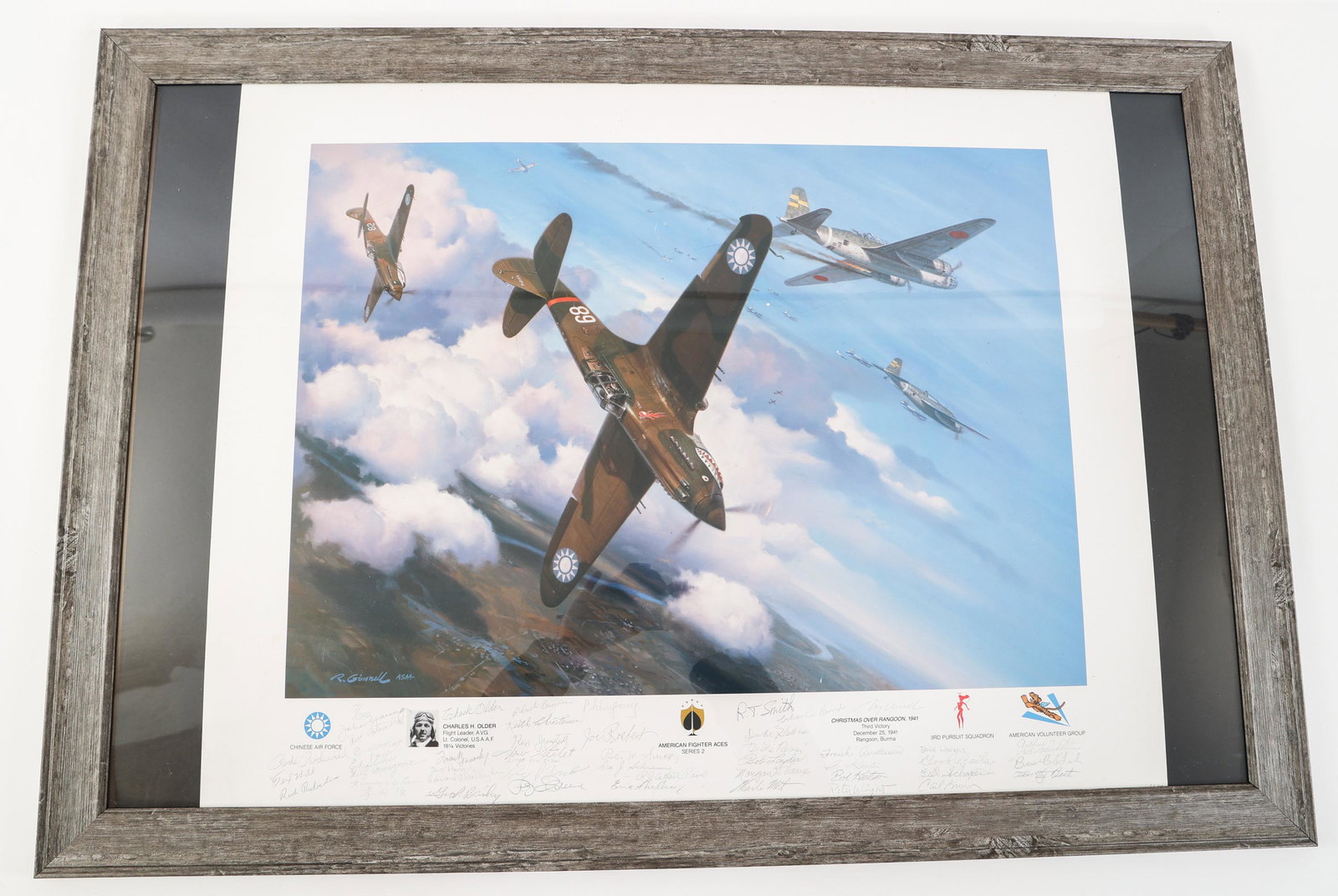 WWII "CHRISTMAS OVER RANGOON" SIGNED LITHOGRAPH: WWII "CHRISTMAS OVER RANGOON" SIGNED LITHOGRAPH Framed "Christmas Over Rangoon" Signed Lithograph. Hand signed and numbered 7/1250 by artist Roy Grinnell, and signed by pilot Charles H. Older, and oth