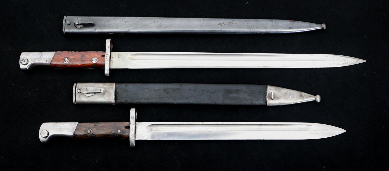 WWI BELGIAN EXPORT & COLUMBIAN M1924 BAYONETS: WWI BELGIAN EXPORT & COLUMBIAN M1924 BAYONETS Lot of 2 WWII Belgian Export and Columbian M1924 Bayonets. (1) Belgian Export M1924 Bayonet. Spear point, bright, straight blade with fuller. No maker mar