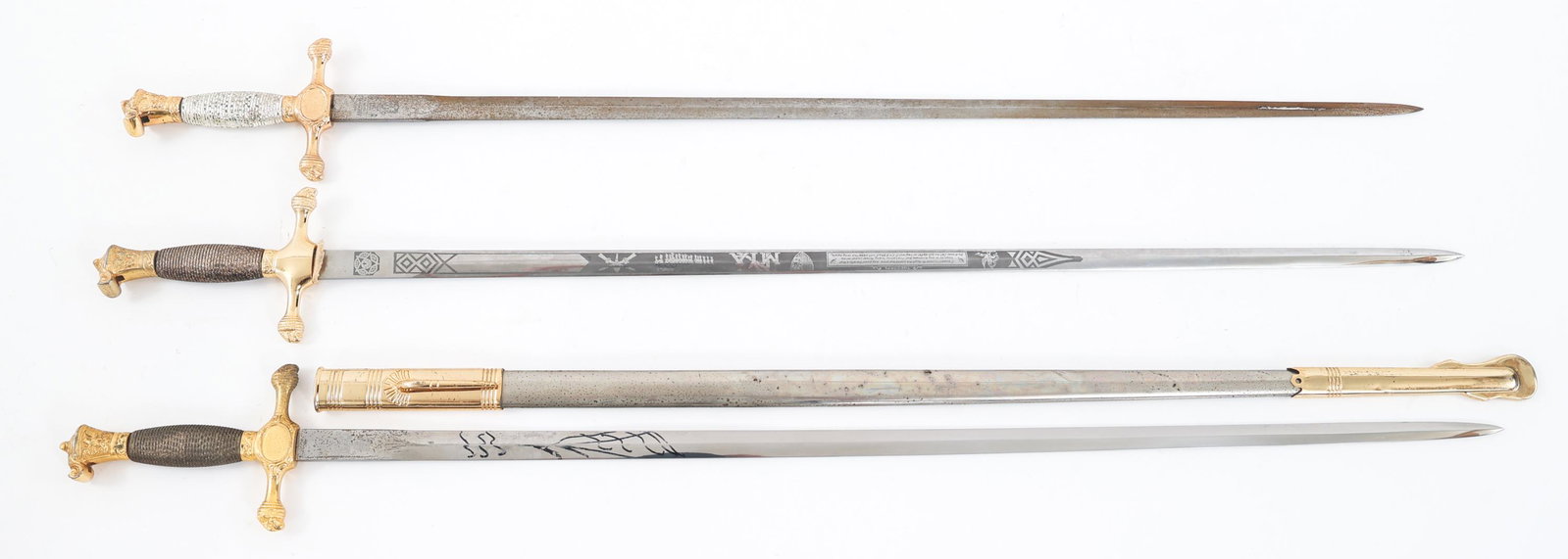 COLD WAR US MILITARY ACADEMY CADET SWORDS LOT OF 3: COLD WAR US MILITARY ACADEMY CADET SWORDS LOT OF 3 Lot of 3 Cold War US Cadet Swords. (1) Double edged bright blade. Double acid etched with light grey background. "New York Military Academy" on one s
