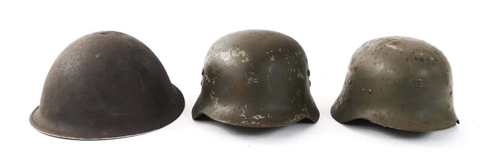 WWII - COLD WAR WORLD MILITARY HELMET LOT OF 3: WWII - COLD WAR WORLD MILITARY HELMET LOT OF 3 Lot of 3 WWII to Cold War World Military Combat Helmets. (1) British Mk.IV steel combat helmet. (1) Spanish M42 steel combat helmet. (1) Hungarian M38 st