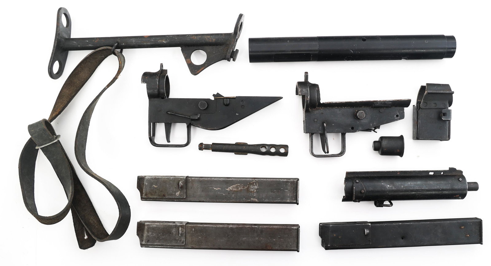 BRITISH STEN SUBMACHINE GUN PARTS KIT: BRITISH STEN SUBMACHINE GUN PARTS KIT British Sten machine gun parts lot. Two trigger housings. Stock. Cut barrel. Demilled magazine housing. Solid aluminum billet dummy receiver. Magazines. Caliber /