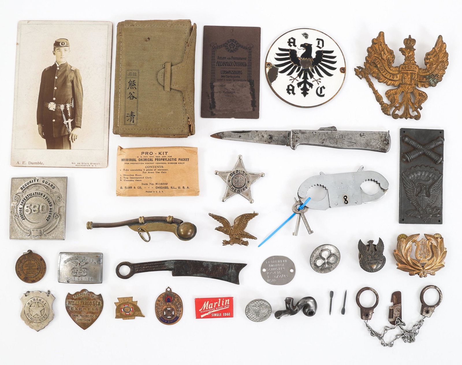 19th C. - COLD WAR WORLD MILITARY INSIGNIA LOT: 19th C. - COLD WAR WORLD MILITARY INSIGNIA LOT Lot of Assorted 19th C. - Cold War World Military & Police Insignia and Thumb cuffs. Includes two pairs of thumb cuffs with keys, photographs of German a