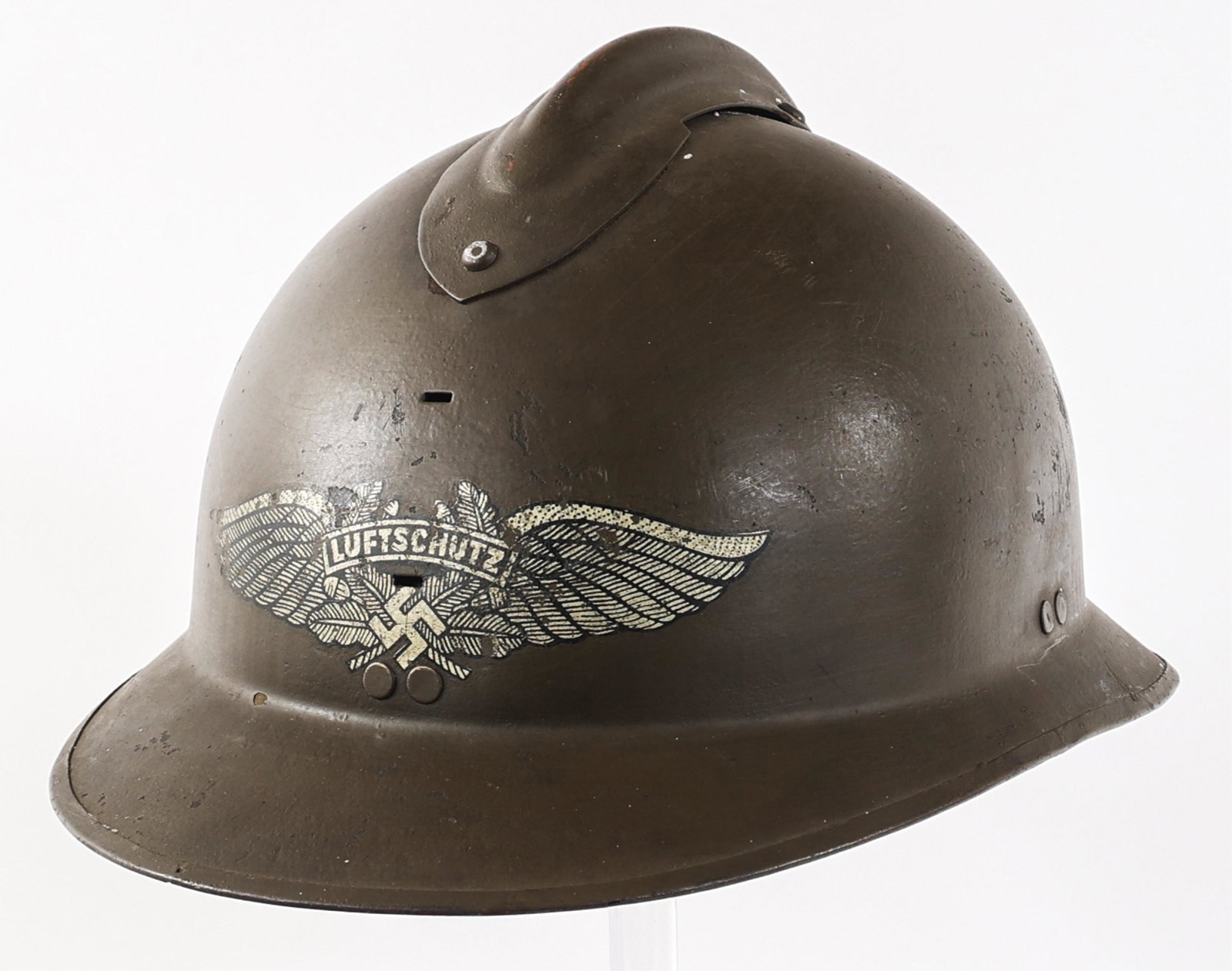 WWII GERMAN LUFTSCHUTZ REISSUED FRENCH M26 HELMET: WWII GERMAN LUFTSCHUTZ REISSUED FRENCH M26 HELMET WWII German Luftschutz Reissued French M26 Helmet. No maker marks or stamps visible inside shell. Luftschutz decal located on front. Complete with lea