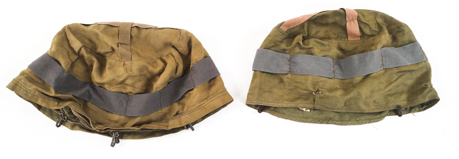 COLD WAR WEST GERMAN FALLSCHIRMJAGER HELMET COVERS: COLD WAR WEST GERMAN FALLSCHIRMJAGER HELMET COVERS Lot of 2 Cold War West German Luftwaffe Fallschirmjager Helmet Covers. Green cotton fabric. All hooks intact. Cotton band with regular vertical seams