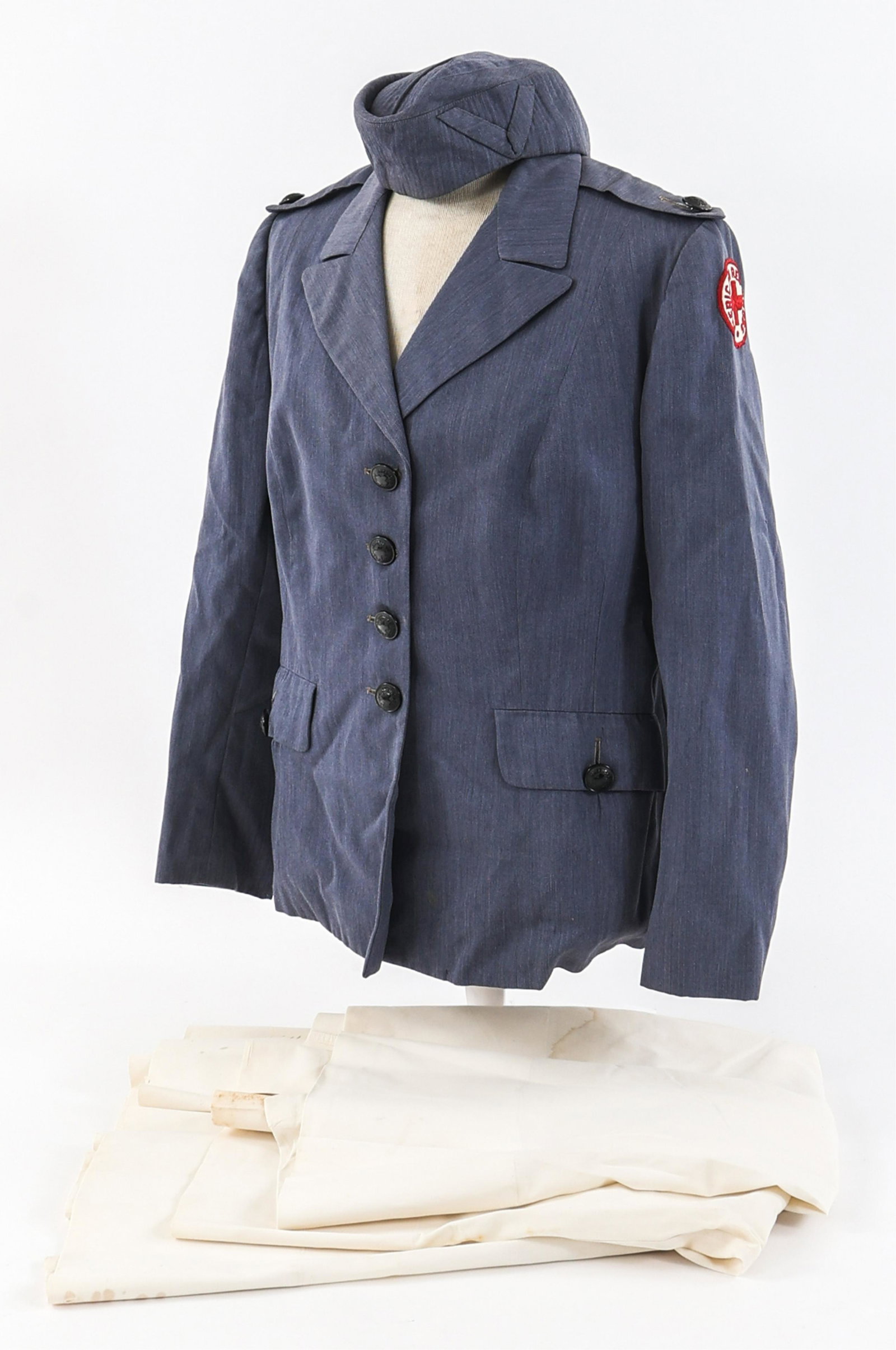 WWII AMERICAN RED CROSS SERVICE DRESS TUNIC: WWII AMERICAN RED CROSS SERVICE DRESS TUNIC WWII American Red Cross Female Service Dress Tunic and Hospital Skirts. (1) ARC Service Tunic. Blue, polyester / wool tunic with American Red Cross shoulder