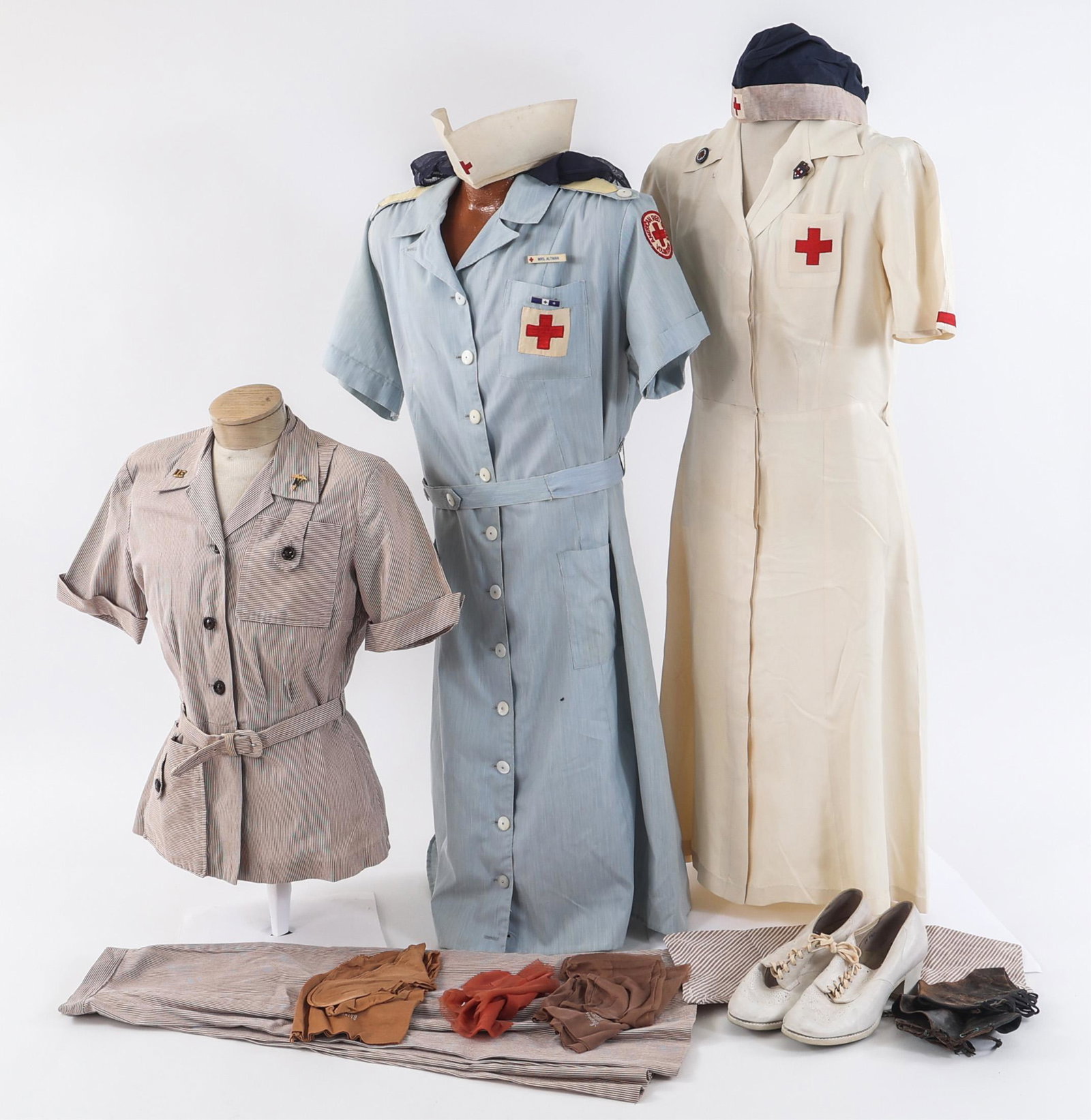 WWII US ARMY NURSE CORPS & ARC HOSPITAL UNIFORMS: WWII US ARMY NURSE CORPS & ARC HOSPITAL UNIFORMS WWII US Army Nurse Corps & American Red Cross Hospital Uniforms. (1) Nurse Corps Uniform Set. Striped cotton seersucker nurse's shirt with Nurse Corps 