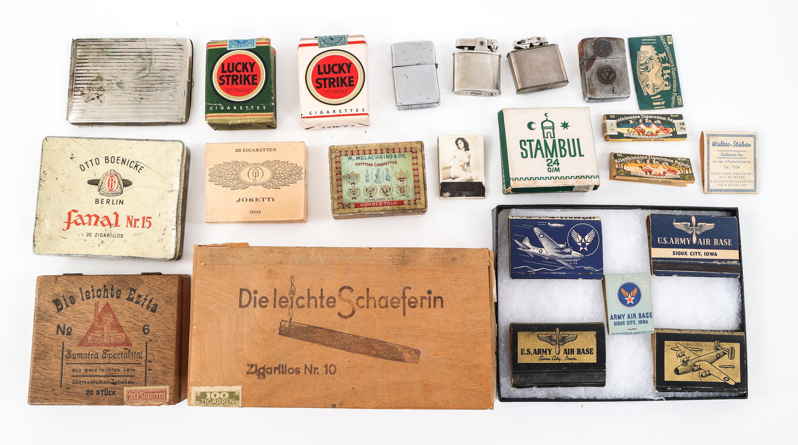 WWII US & GERMAN LUCKY STRIKES / ZIPPO & MATCHES: WWII US & GERMAN LUCKY STRIKES / ZIPPO & MATCHES WWII US and German Lucky Strikes, Zippo and other cigarette lighters, Matchbooks, and Cigarettes. (2) Packs of Lucky Strikes, Green pack series 112 (op