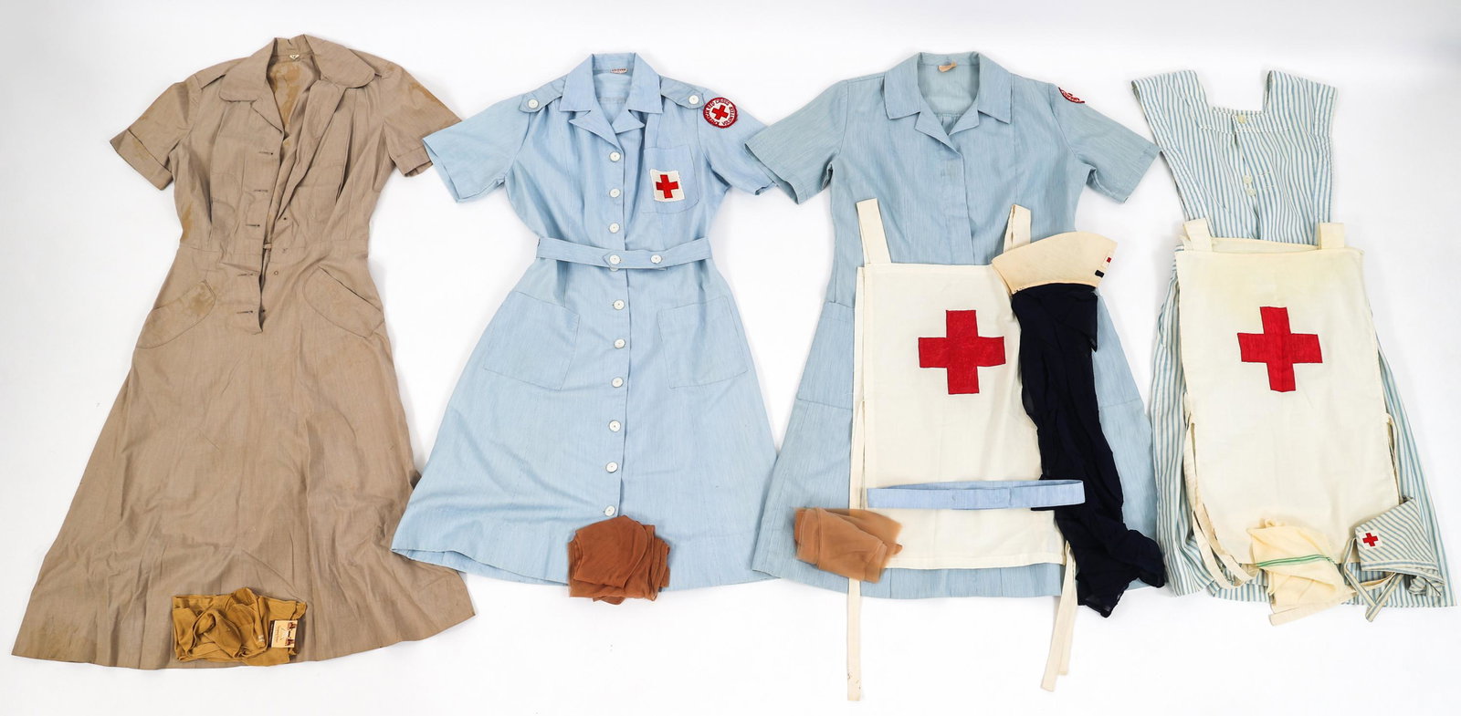 WWII US ARMY NURSE CORPS & ARC UNIFORM LOT OF 4: WWII US ARMY NURSE CORPS & ARC UNIFORM LOT OF 4 Lot of 4 WWII US Army Nurse Corps & American Red Cross Uniform Sets. (1) ANC Off-Duty Dress Uniform Set. Khaki dress and pair of nylon stockings. (1) AR