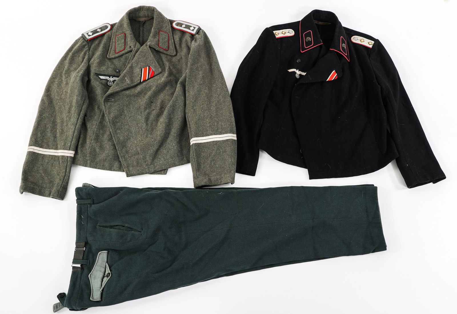 REENACTOR WWII GERMAN UNIFORMS: REENACTOR WWII GERMAN UNIFORMS Lot of 3 Reenactor Contemporary Post-War Production WWII German Uniform Items. (1) Panzer wrap tunic. (1) Assault Gun Wrap Tunic. (1) Pair of trousers. Size: Small to la