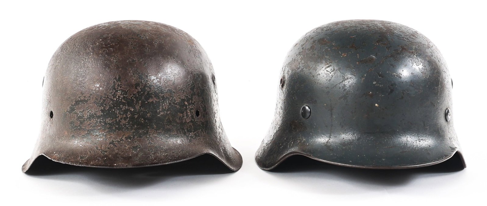 WWII GERMAN M40 & M42 COMBAT HELMET LOT OF 2: WWII GERMAN M40 & M42 COMBAT HELMET LOT OF 2 Lot of 2 WWII German M42 Combat Helmets. (1) Heer M42 Helmet. Single decal. No chinstrap or liner. Maker mark of Eisenhüttenwerk and serial number "1927" 