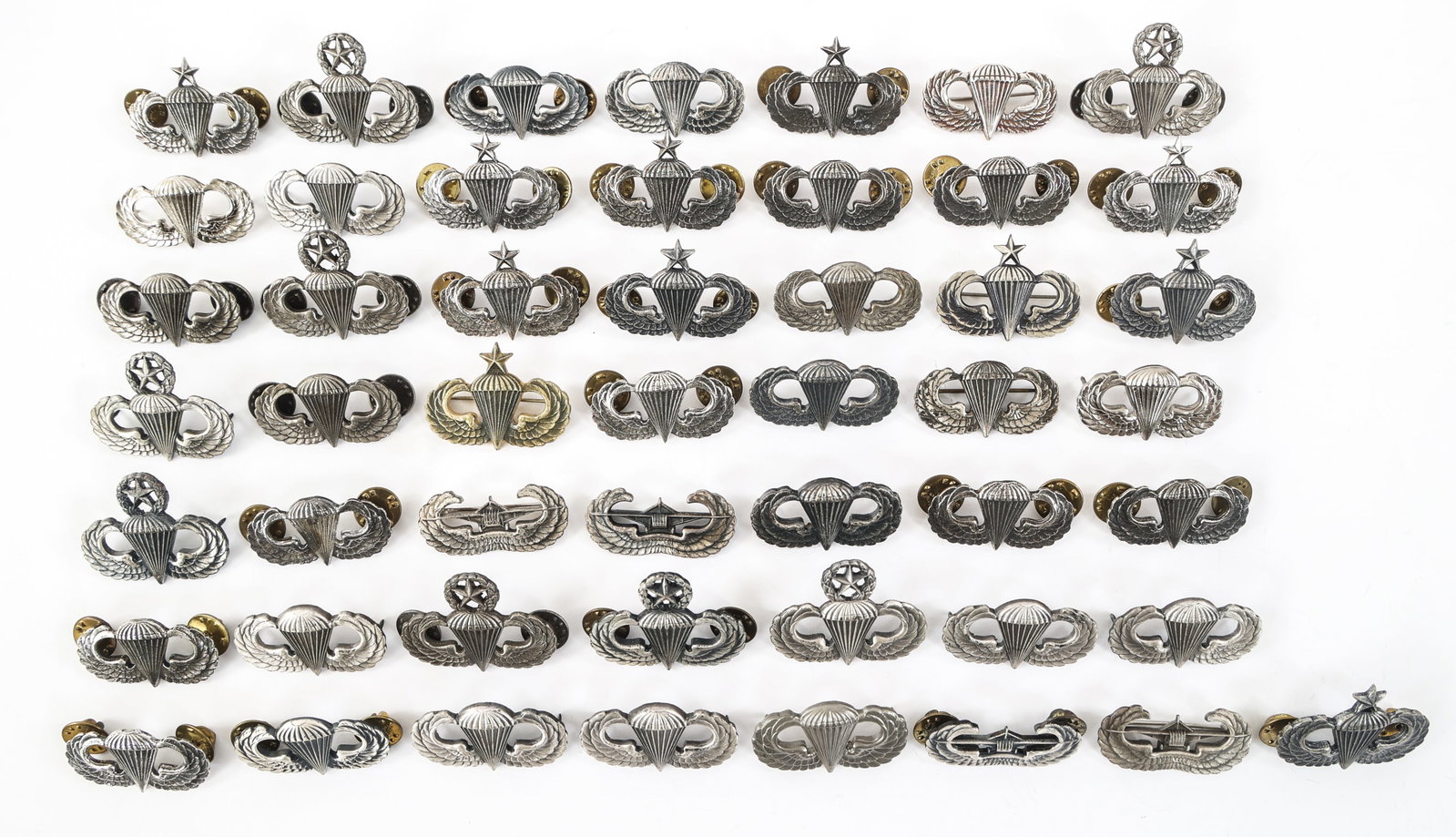WWII - COLD WAR US ARMY JUMP WING BADGE LOT OF 50: WWII - COLD WAR US ARMY JUMP WING BADGE LOT OF 50 Lot of Approximately 50 WWII - Cold War US Army Jump Wing Badges. Also includes Glider, Senior, and Master badges. Some are marked "Sterling" on the b