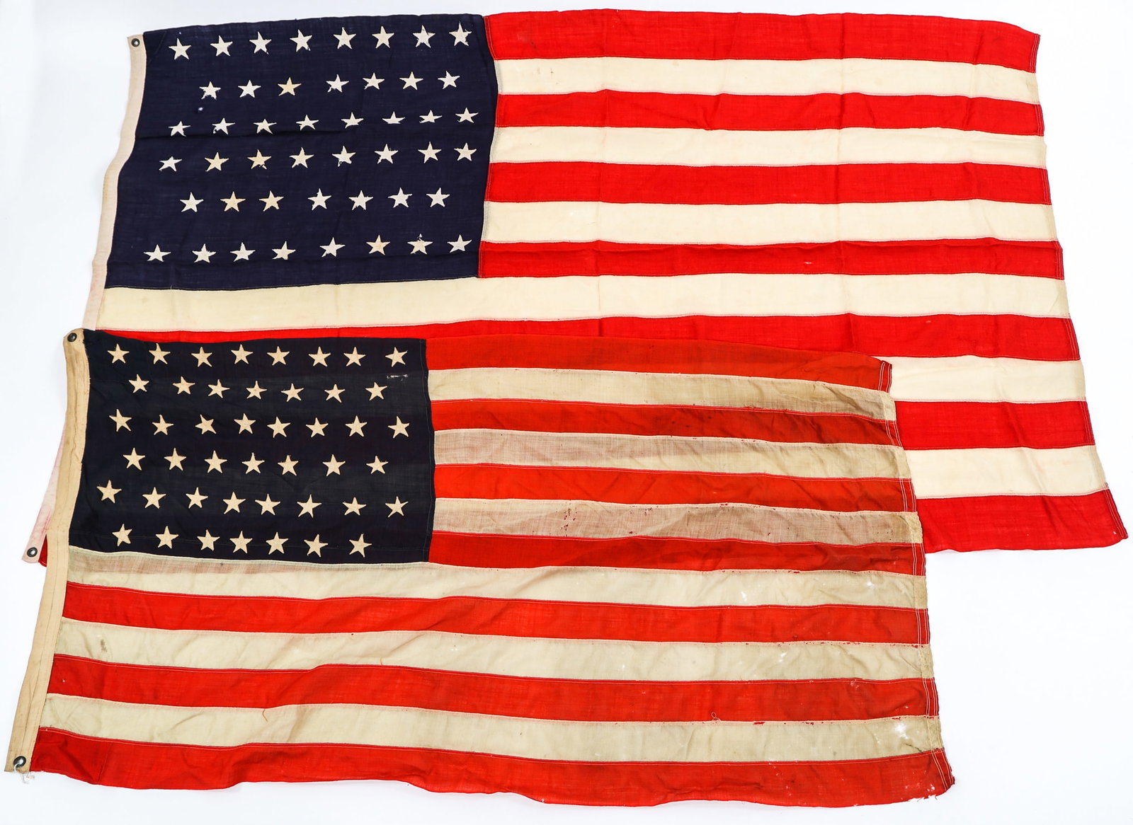 SPAN-AM WAR - EARLY 20th C. US 45 & 46 STAR FLAGS: SPAN-AM WAR - EARLY 20th C. US 45 & 46 STAR FLAGS Lot of 2 Spanish-American War - Early 20th Century 45 and 46 Star Flags. (1) 45 Star Flag. Multi-piece canvas construction. Size: 3" x 6". (1) 46 Star