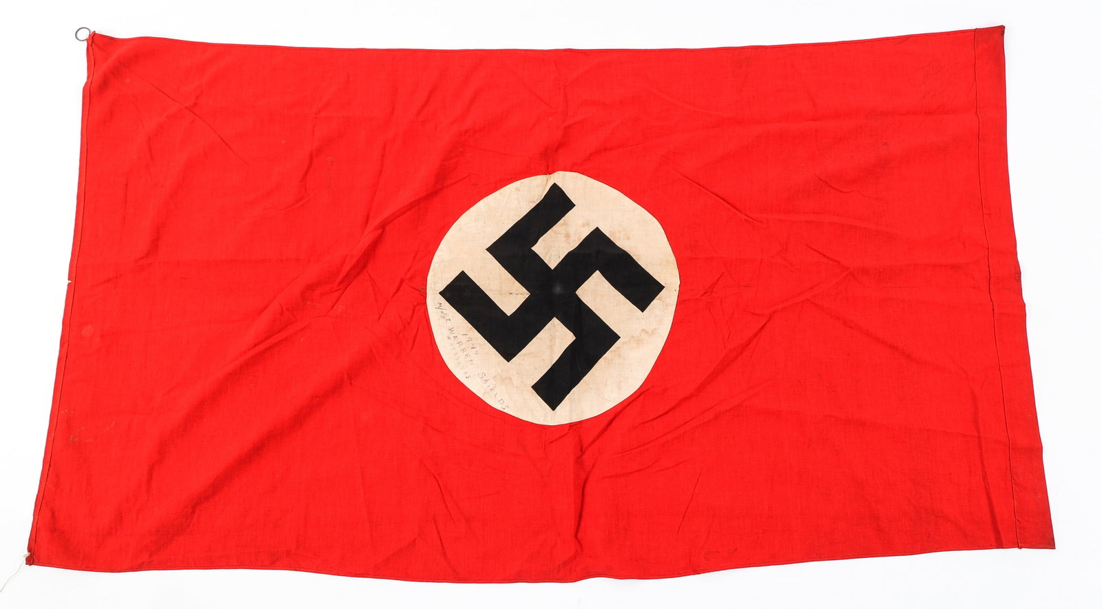 WWII US CAPTURED GERMAN NSDAP FLAG: WWII US CAPTURED GERMAN NSDAP FLAG WWII US Captured German NSDAP Flag. Double sided, multi-piece construction, and printed swastika. Signed "1944 M/Sgt Warren Shields #35336738" on the white circle on