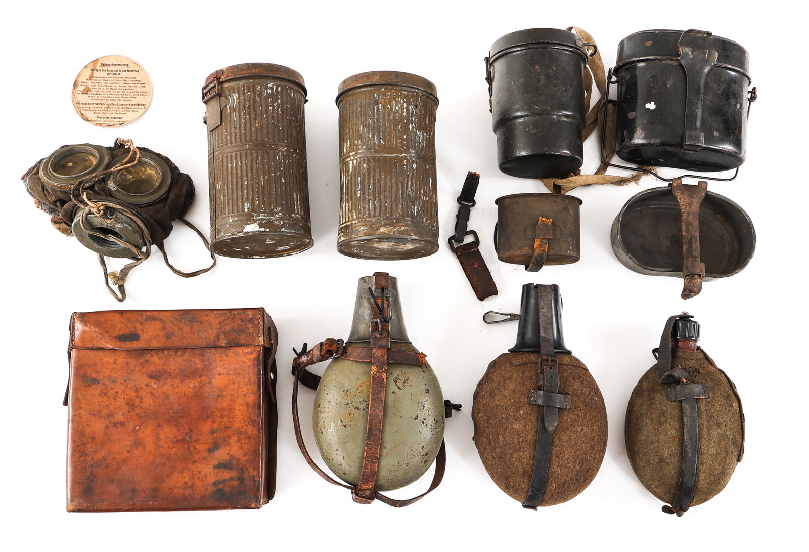 WWI - WWII GERMAN ARMY CANTEEN & FIELD GEAR LOT: WWI - WWII GERMAN ARMY CANTEEN & FIELD GEAR LOT Lot of WWII German Army Field Gear. Includes M31 Canteens with bakelite and steel cups, M31 Mess kits, gas mask containers, Officer's medical pouch and