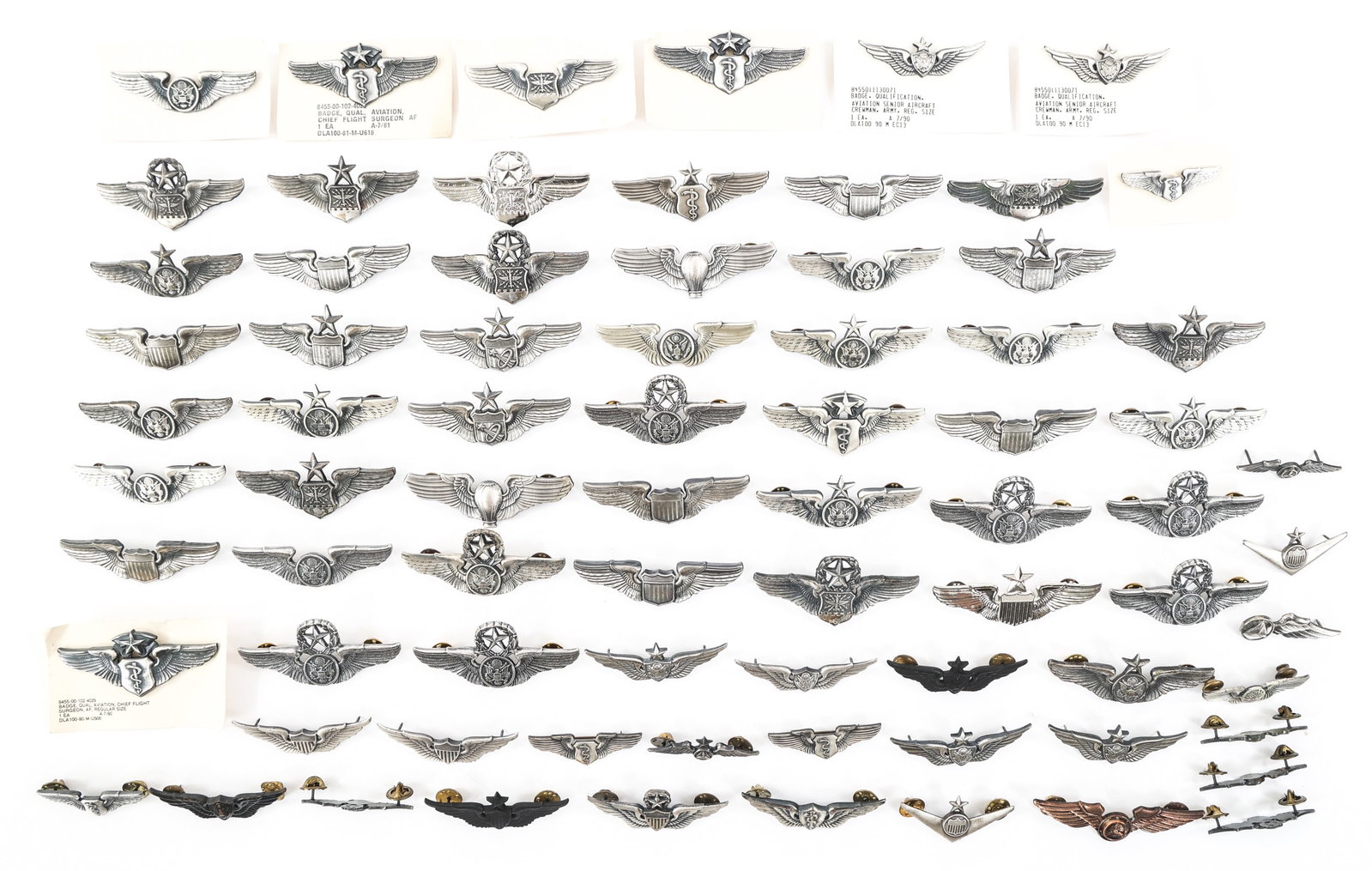 WWII - COLD WAR US PILOT & AIRCREW WINGS LOT: WWII - COLD WAR US PILOT & AIRCREW WINGS LOT WWII - Cold War US Pilot and Aircrew Wings. Includes pilot, chief flight surgeon, senior Aircrewman, balloon pilot, observer, and more. Weight: 3lbs