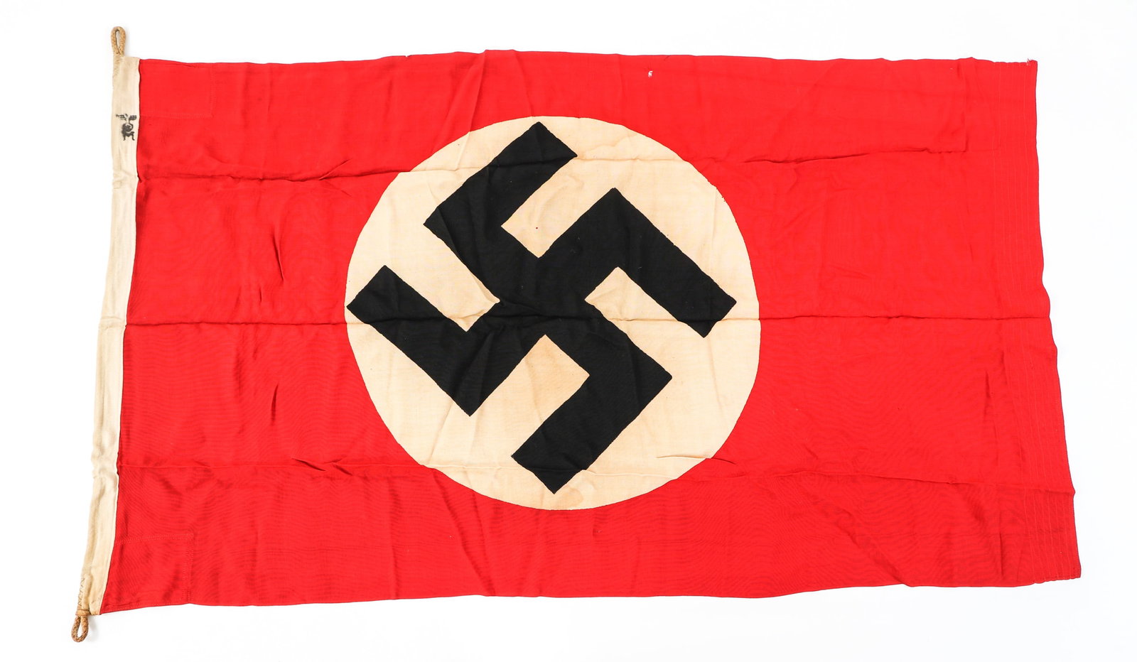 WWII GERMAN NSDAP FLAG: WWII GERMAN NSDAP FLAG WWII German NSDAP Flag. Double sided, single piece, cotton construction with printed emblem. Reinforced header with rope. German eagle and "M" ink stamped on header. | Size: 29"