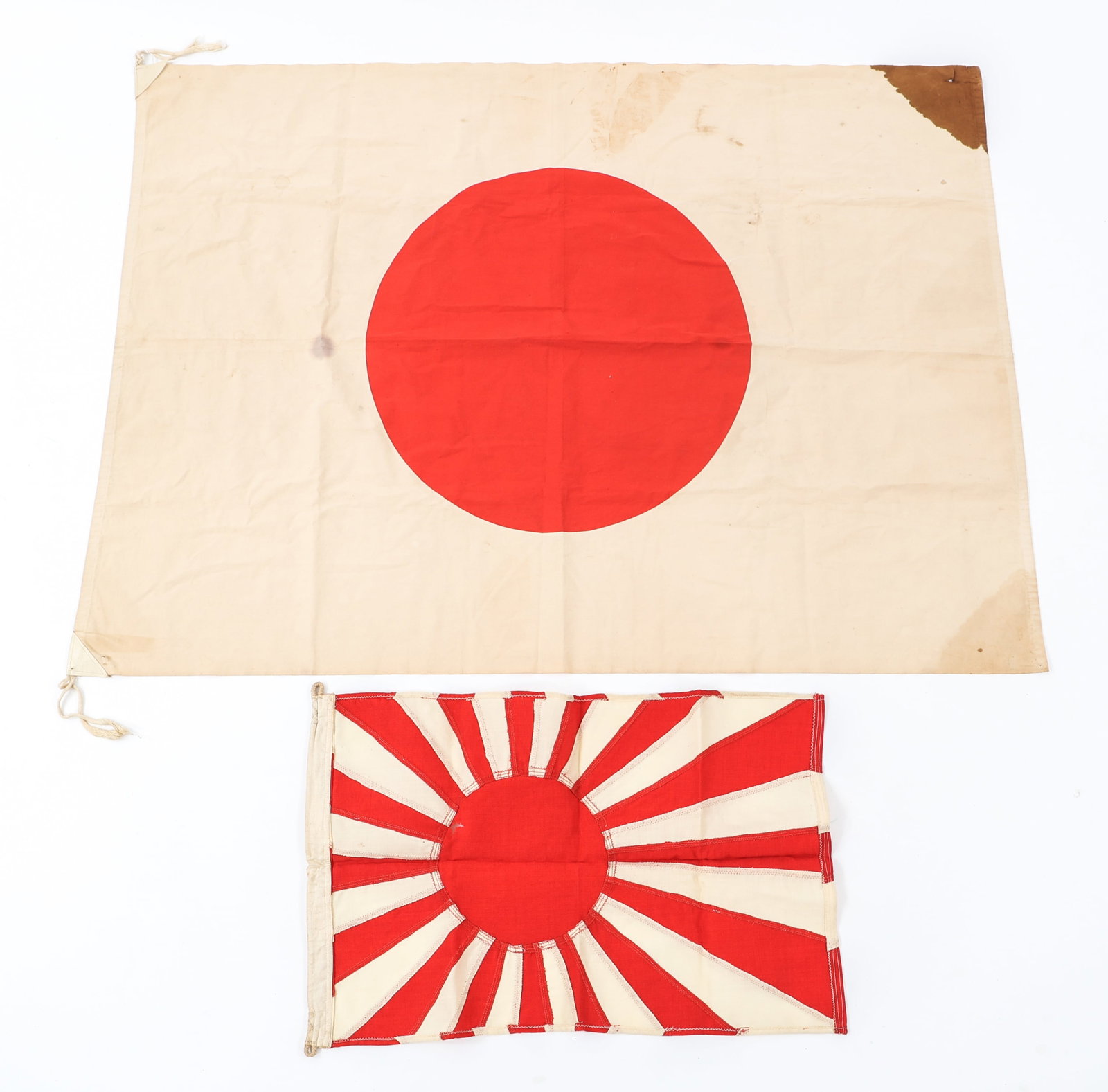 WWII IMPERIAL JAPANESE NATIONAL & NAVAL FLAGS: WWII IMPERIAL JAPANESE NATIONAL & NAVAL FLAGS WWII Imperial Japanese National and Naval Flags. (1) Japanese National Flag. Double sided, single piece cotton construction with printed emblem. Leather r
