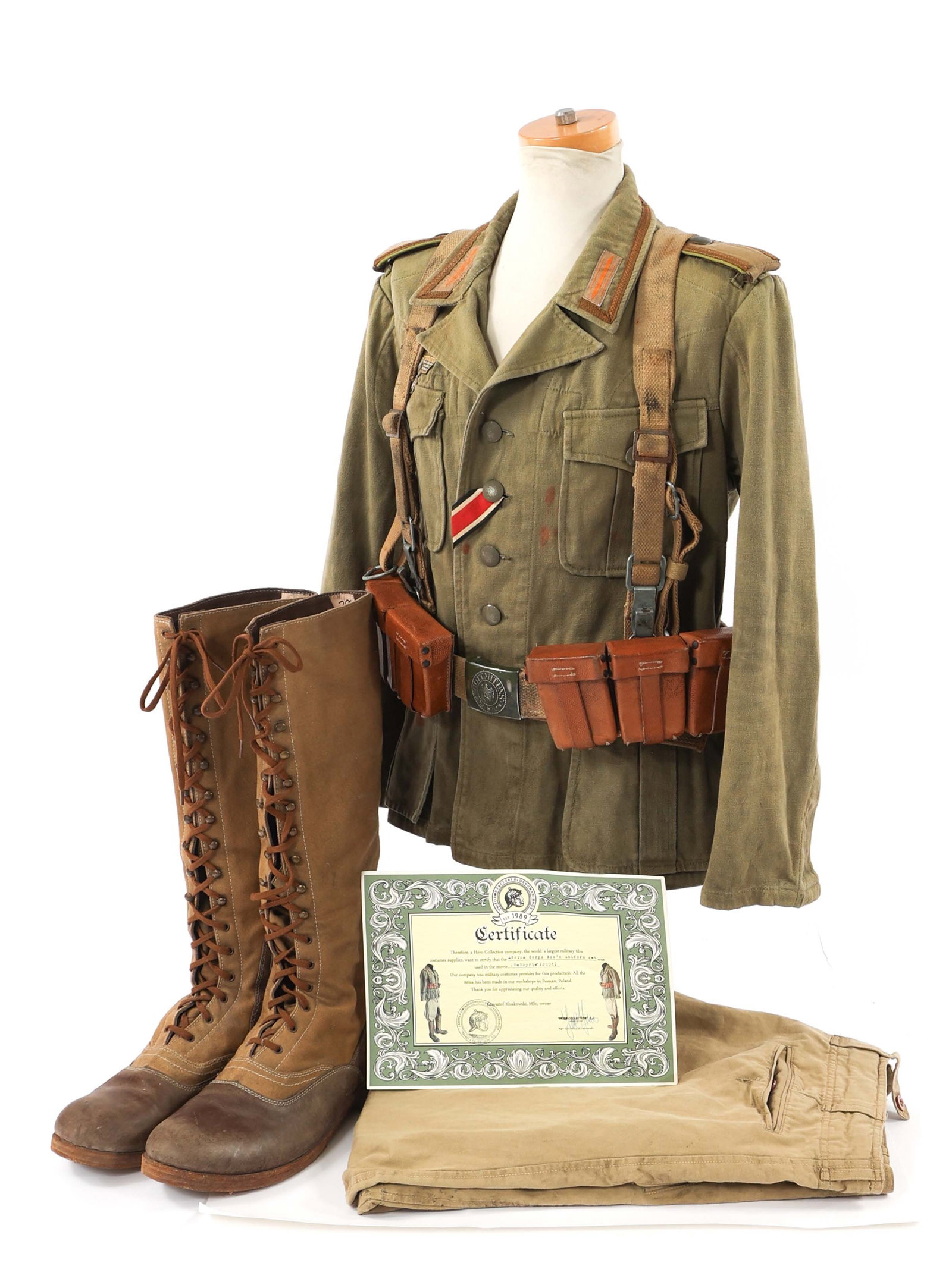 2003 "VALKYRIE" WWII GERMAN NCO MOVIE PROP UNIFORM: 2003 "VALKYRIE" WWII GERMAN NCO MOVIE PROP UNIFORM "Valkyrie" WWII German Afrika Korps NCO Movie Prop Uniform. Includes tunic, suspenders with cartridge pouches, breeches, and boots. Certificate by Un