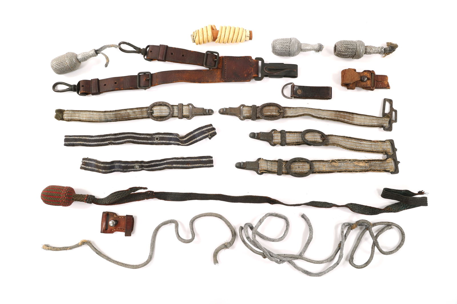 WWII GERMAN DAGGER HANGERS & ACCESSORIES: WWII GERMAN DAGGER HANGERS & ACCESSORIES WWII German Dagger Hangers & Accoutrements. Includes hangers and hanger parts, off white celluloid handle, portepees and portepee threads.