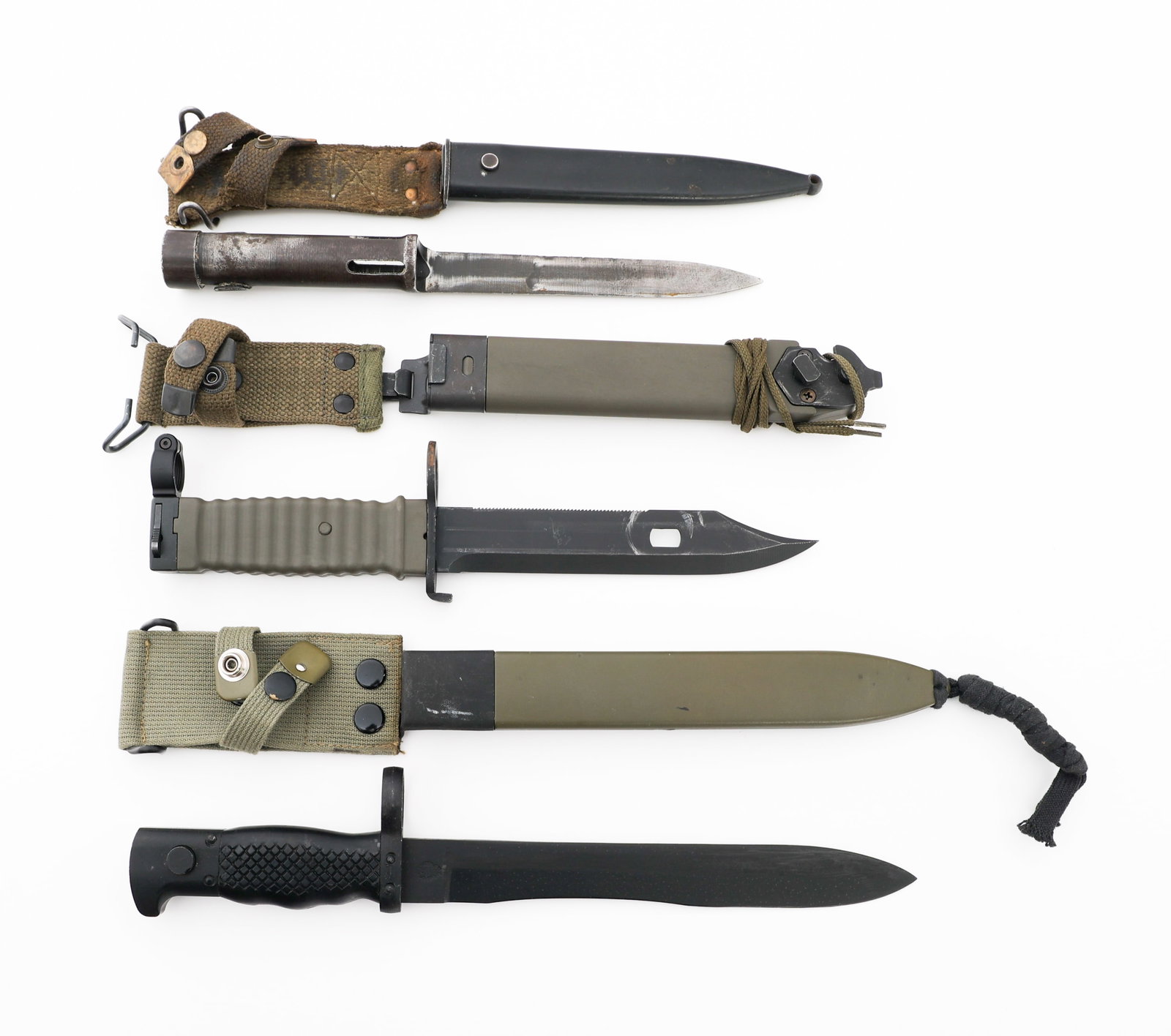 COLD WAR WEST GERMAN, BELGIAN, & SPANISH BAYONETS: COLD WAR WEST GERMAN, BELGIAN, & SPANISH BAYONETS Cold War West German, Belgian, & Spanish Bayonets. (1) West German KCB-77 Bayonet. No visible marks or stamps. Green plastic scabbard with wire cutter